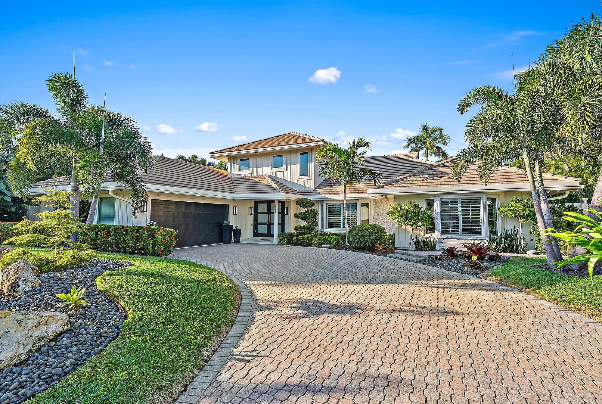 Nestled in the prestigious Olympus neighborhood, this stunning coastal retreat offers the perfect blend of modern elegance and tropical tranquility. Just steps from the Atlantic Ocean, this exquisite residence provides deeded beach access, allowing you to enjoy Jupiter's pristine shoreline at your leisure.The home is surrounded by lush landscaping, offering ultimate privacy and serenity. Inside, soaring ceilings and an open floor plan create an inviting and airy atmosphere. The sleek, contemporary kitchen features custom cabinetry, quartz countertops, a spacious island, and high-end appliances. Expansive living and dining areas are bathed in natural light, with floor-to-ceiling windows allowing for seamless indoor-outdoor living. The luxurious primary suite boasts a spa-like en-suite bath, dual vanities, and a generous walk-in closet. High-gloss porcelain floors, modern finishes, and designer touches enhance the home's sophisticated appeal.
The private outdoor oasis is designed for relaxation and entertaining, featuring a heated pool surrounded by lush tropical landscaping. A covered patio and outdoor lounging areas provide the perfect setting to enjoy Jupiter's coastal lifestyle.
Located in one of Jupiter's most sought-after communities, Olympus offers tranquil lakes, tree-lined streets, and a prime location close to top-rated dining, shopping, golf courses, and marinas. This exceptional home is a rare opportunity to own a piece of paradise in one of South Florida's premier coastal enclaves.