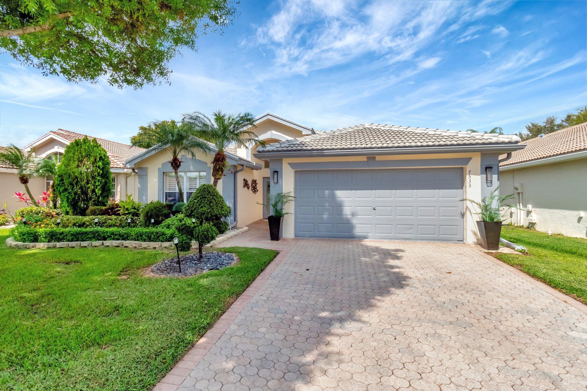 NEW ROOF 2022Presenting 7533 Sagunto Street, located in the prestigious Valencia Lakes community of Boynton Beach, Florida; where luxury and resort-style living converge. This exquisite residence welcomes visitors with its perfect blend of elegance and modern comfort, draped in the essence of coastal Florida sunlight. Equal parts aesthetic charm and functional design, the home's floor plan see-saws between openness and division in a flawless dialogue.Upon arrival, high vaulted ceilings echo the grandeur of the resort-like community, while the profound abundance of natural light accentuates the strikingly polished renovations noteworthy throughout the home. The floor plan, split yet open, allows sunlight to softly illuminate versatile spaces that transition seamlessly into each other - a key ingredient of practical luxury. Continuous flow interweaves the formal dining room and the living room, leading into an immaculate eat-in kitchen characterized by quartz countertops, a stylish designer tile backsplash, and custom wooden cabinetry. A fine display of quality appliances, including a brand-new refrigerator, invite culinary exploration.

Amplifying the sheer elegance further, a stunning tray-ceiling in the master suite creates a serene, inviting ambiance. Achieving the perfect balance of form and function, the suite boasts dual walk-in closets with ample storage and a renovated bathroom outfitted with a modern touch - quartz countertops, custom wooden cabinets, and impressive spa-like walk-in shower that provides a private retreat within the home.

Transitioning to the house's exterior, an oversized screened-in patio advocates for open-air relaxation, primely positioned to overlook the lushly landscaped backyard. As a practical addition to its distinguished aesthetics, the home features a new roof (2022), impact French doors, a new air conditioner, and a newly epoxied garage, which ensure that function meets form.

The Valencia Lakes community outshines an opulently renovated clubhouse, pickleball courts, and a wealth of other amenities that echo the upscale lifestyle it offers - from fitness centers, an on-site restaurant, and more. Welcome home to 7533 Sagunto Street, where comfortable living meets resorts' sophistication and grace.