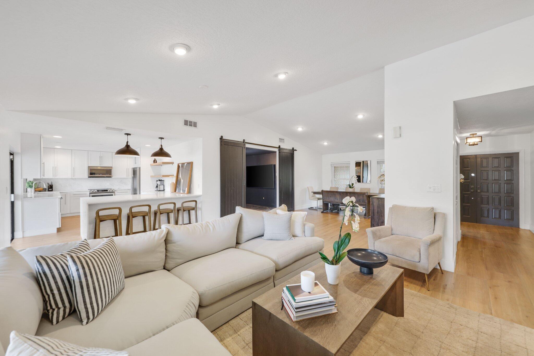 Welcome to this stunning, fully renovated home in Paseos, one of Boca Raton's most sought-after communities--where homes rarely become available. As you step inside, you'll immediately notice the open-concept design, enhanced by beautiful oversized white oak plank tile throughout. The kitchen is a true centerpiece, featuring a stunning translucent quartzite oversized peninsula with seating for 6-8. White oak floating shelves, custom soft-close pull-out drawers, and ample cabinetry. A dedicated movie room offers the perfect space to unwind for a cozy night in or entertain guests. This versatile room can also be converted into a bedroom, office, or playroom to fit your needs and lifestyle. Additional features include a brand-new washer and dryer, some impact windows, shutters throughout, a a newer AC (3 years old), and most appliances replaced within the last 3 years. Both the master and guest bathrooms have been beautifully remodeled.

Step outside into a true South Florida tropical setting, where mango, star fruit, and banana trees surround the property. The backyard is designed for both relaxation and entertaining, featuring a swimming pool, a newly added white fence, a covered patio with space for lounging and dining, an outdoor shower, and a large grass area along the side.

Located in a gated community with two entrances, an A+ school zone, and a low HOA, this home also offers an unbeatable east/central Boca Raton location. Just minutes from I-95, the Turnpike, beaches, top restaurants, and Town Center Mall, this is truly a rare opportunity in Paseos. Don't miss it!