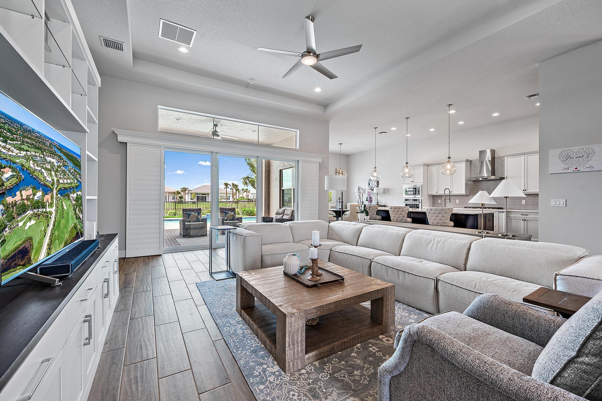 Welcome to 9985 Timber Creek Way, where you can live your best life now in an incredible home upgraded beyond the models with tremendous builder enhancements and extensive post-closing renovations. Located in the exclusive Regency at Avenir, a gated 55+ community, this 3-bedroom, 3-bath home is a rare opportunity to own a fully customized, move-in-ready retreat.Luxury starts at the custom full-length double glass entry doors and continues inside with California Custom Closets in all bedrooms, built-in lighted cabinetry, whole-home plantation shutters, designer lighting, and remote-controlled ceiling fans. The garage is upgraded with a polyaspartic floor, ultra-quiet Chamberlain opener with a camera, and an outdoor keypad. Step outside to your private backyard oasis, featuring a saltwater pool with LED lighting and full automation, an outdoor power screen for the lanai, and a fully equipped summer kitchen with a built-in grill, sink, and storage. Extensive landscaping with lighting, industrial mesh fencing, and a Generac full-home generator provide both beauty and functionality.
Beyond your doorstep, the Regency clubhouse offers a golf simulator, fitness center, pickleball, tennis, firepit lounge, card rooms, and an art studio, all set in a lush tropical resort setting.
This is your chance to own a truly one-of-a-kind, designer-upgraded home beyond the builder model. Schedule your private tour today!