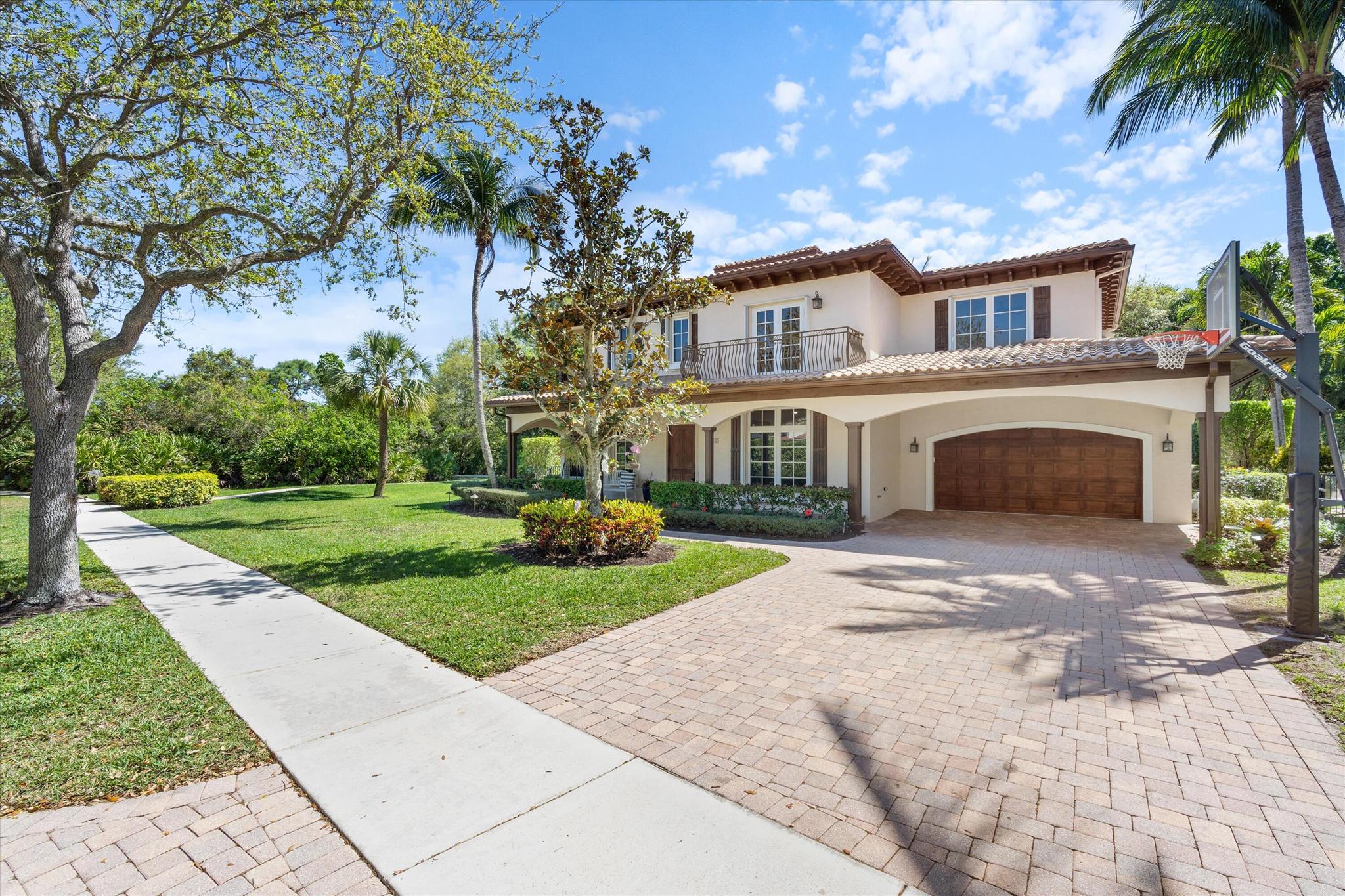 Welcome to this stunning Mediterranean-style 5-bedroom, 4 1/2 bathroom home, nestled in one of the largest corner lots of the highly sought-after Valencia neighborhood at Abacoa.  Surrounded by beautiful greenery and showcasing striking curb appeal, this home includes a covered front porch, arched entryways and a second floor balcony that adds elegance, making it stand out in the neighborhood.  This private residence offers a perfect blend of space, style and functionality.The home has been meticulously renovated, with a beautifully updated first floor that features an open, light-filled layout with soaring 20-foot ceilings. New oak hardwood floors throughout the entire home provide a sleek, modern touch. The chef's kitchen is a true highlight, featuring luxurious Cristallo countertops