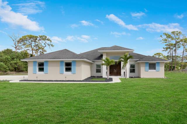 A SHOW STOPPER! Unbelievable home loaded with upgrades! This beautiful CBS home was built in 2018 and sits on over an acre of land in the heart of Loxahatchee. Walk inside to find yourself greeted with the newest trends in flooring and finishes complemented by an open floor concept perfect for entertaining. The kitchen has been recently updated with  high-end appliances, granite throughout, dual Sub-Zero refrigerators and an oversized island fit for a chef! This home is equipped with a custom pool with sun deck which was built in 2022 making the back yard a private tropical oasis perfect for entertaining! This home is complete with hurricane impact windows, energy efficient appliances along with a reverse osmosis system. Call for a private showing today before this house goes pending!