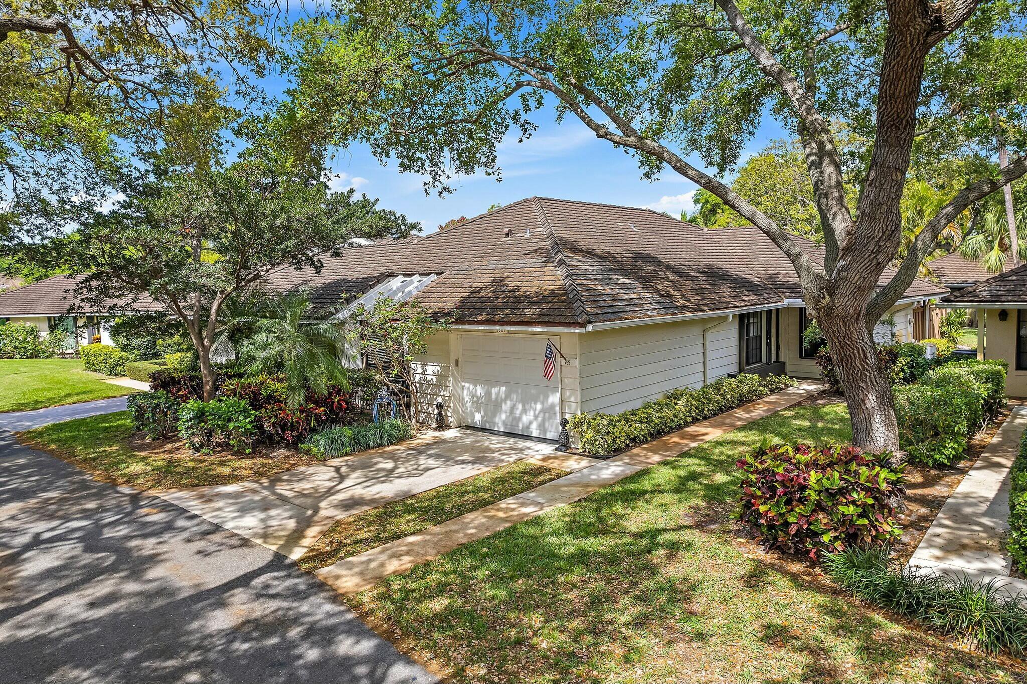 Beneath the oaks, a tranquil, carefree lifestyle awaits in this updated one-level three bedroom villa, with private garage, in gated Twelve Oaks! Entertain in the great room with tray ceiling and crown molding, or gather together in the dining room area. Remodeled kitchen features updated cabinetry, granite counters, stainless-steel appliances, bar-height seating, wet bar with wine cooler, and eat-in area overlooking the front paver patio. Retreat to the Primary suite, with tray ceiling, finished in wood floors, inviting Primary bath with dual sink granite vanity, separate shower, and spacious closets. Two additional guest rooms, including an office with tongue-and-groove ceiling and custom built-ins, share a remodeled bath with glass vanity and walk-in shower/tub. Relax on the covered lushly landscaped, tile patio with granite counter bar, and newer composite fence, overlooking the green space and oak trees beyond. Private driveway leads to a one-car garage, with extra storage and generator connection. Association dues include roof maintenance, building insurance, landscaping, plus a variety of amenities, and boat slips may be available within the community, by separate agreement.

Enjoy all that gated Twelve Oaks has to offer: manned/gated security, marina, clubhouse, on-site management, pools, tennis, and pickleball, all minutes down PGA Boulevard to endless outdoor activity, shopping, dining, and the Palm Beach International Airport!