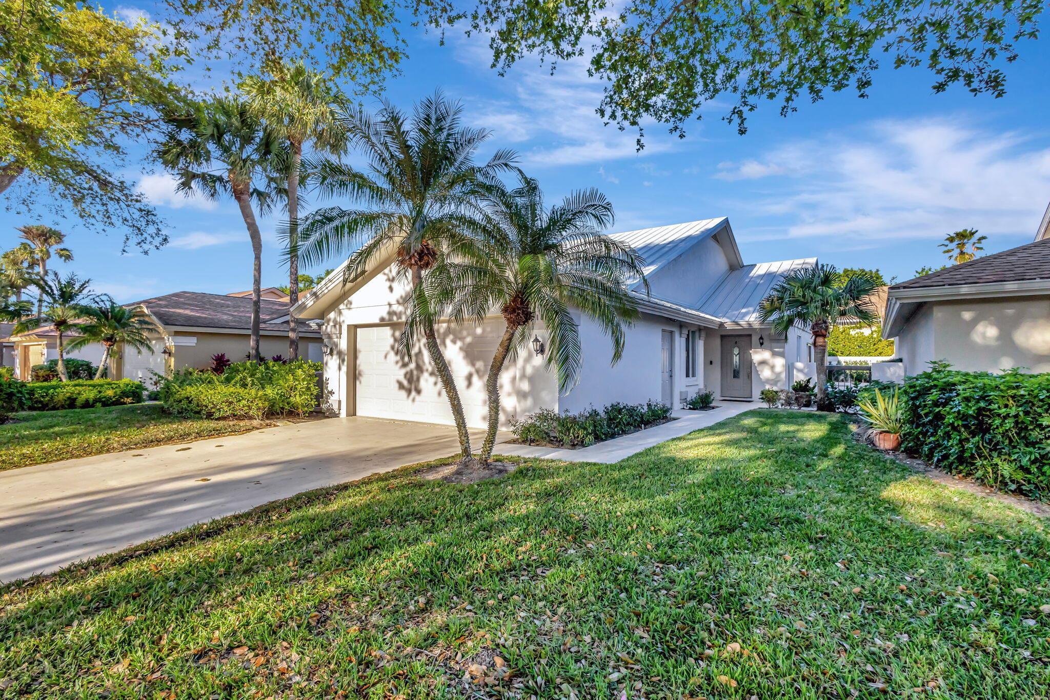 Welcome to this beautifully renovated 3-bedroom, 2-bathroom home in the highly sought-after Ridge at the Bluffs community. This exquisite residence boasts a new metal roof, impact windows and doors throughout, and high-end finishes that make it truly move-in ready. Step inside to find spacious living areas with 36'' x 36'' tile flooring, elegant lighting, and sliders throughout, creating a bright and open ambiance. The gourmet kitchen is a chef's dream, featuring Bosch appliances, a built-in espresso/coffee maker, a wine cooler, high-end custom cabinetry, and an exterior-vented exhaust fan. The primary suite offers a spa-like retreat with a frameless glass shower, separate soaking tub, dual sinks, and a luxurious rain showerhead. Additional highlights include an office space, custom mirror and glass closet doors, a separate indoor laundry room, and a large, beautifully landscaped patio&#x14;perfect for relaxation or entertaining Located in a vibrant community of 618 single-family homes, residents enjoy resort-style amenities, including a swimming pool, children's wading pool, playground, basketball court, two tennis courts, and four pickleball courts. Picturesque sidewalks lined with lush oak trees and tropical landscaping add to the charm of this exceptional neighborhood. Conveniently situated close to restaurants, shopping, and easy highway access, this home offers both luxury and convenience in the heart of Jupiter. Don't miss this incredible opportunity&#x14;schedule your showing today!