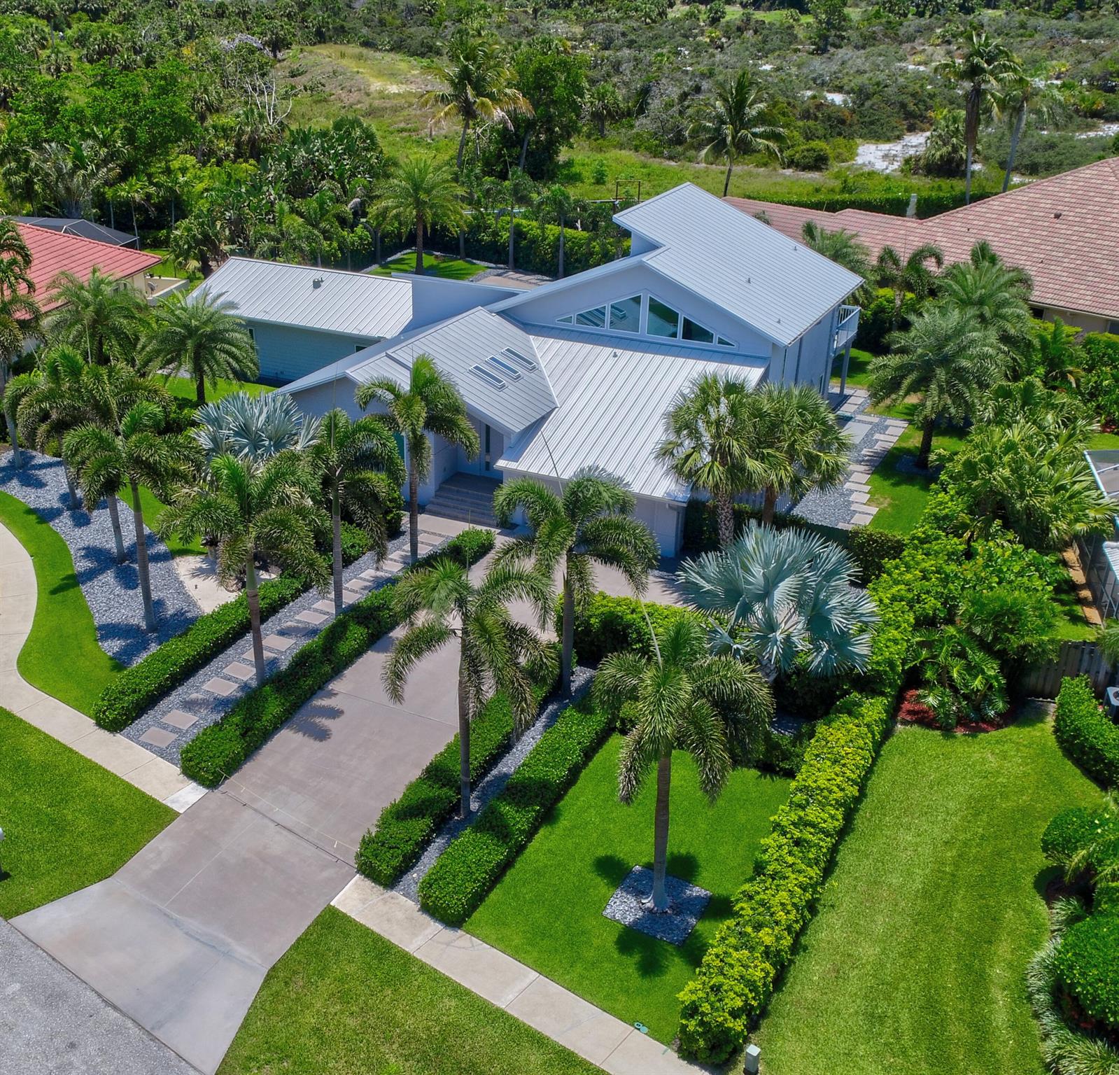 Gorgeous home close to the beach path in coveted Olympus. 5 min to Safe Harbor Marina w/deep water moorage avail.Incredible opportunity to purchase a home on almost 1/2 acre that has been elevated to the highest standards. New Roof 2024 & Low-e insulated impact glass, Euro-Modern kitchen w/luxury Miele/Bosch appliances incl. steam oven, espresso machine. Imported porcelain floors throughout. Primary suite w/coffee bar, custom closet, New Brazilian walnut(IPE) hardwood deck overlooking pool + preserve. 3 guest bedrooms,1 suite has seperate entry w/kitchenette- could be Primary wing. Ultimate pool (53'x25') surrounded by expansive landscape dotted w/palms. Salt system w/UV, Ozone sanitizer, Heated, LED lighting. Newer 3-zone AC system w/insulated ductwork. State-of-the-Art audio+security. Enjoy dining alfresco in well-equipped spacious summer kitchen. Tropical landscape provides privacy and several outdoor living spaces, including a tranquil courtyard with putting green. CAN BE PURCHASED FULLY FURNISHED. Easy jaunt to the restaurants, boutiques &amp; day spa at the Driftwood Plaza. Close to Marinas, Golf, Tennis, and the Jupiter Riverwalk. 30 MIN COMMUTE TO WEST PALM BEACH

OVERVIEW:
Remodeled down to the studs in 2015/2016 with attention to detail and functionality
New metal roof in 2024
Hardi-plank cement fiberboard siding
Stem wall foundation - top of the line construction
Newer 3- zoned air conditioning system with high efficiency, high systems (2022/23)
INSULATED ductwork throughout entire home
FULL Impact glass
500 Gallon Propane Tank installed 2019
Gas pool heater installed 2019
Stiebel Eltron heat pump water heater and recirculating hot water in main house.
Guest wing has separate On-Demand EcoSmart 11 tankless hot water
Miami Dade-rated PGT Low E insulated windows and sliding glass doors. 
Italian rectified porcelain tiles in living area and Imported porcelain from Spain in bedrooms
Pocket slider in Living Room for 16 feet of openness to outside deck and pool area
Guest or Primary wing has several options for separate living area
USB outlets throughout the entire home
Whole house water filtration system and salt-free water softner
Professionally landscaped with privacy hedges, palms, courtyard, putting green and more.