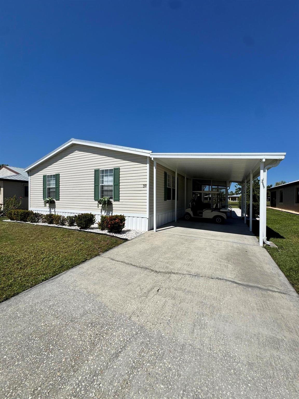 Lovely lake view 3 bedroom 2 bath home in the desirable 55+ Spanish Lakes Country Club Village community. Home is a 3 bedroom with living and family room. Screened in patio for enjoying morning coffee or evening cocktails. Home has beautiful lake view. New metal roof 2024. Home has carpet and laminate. Beautiful landscaping. Land lease fee includes trash removal, lawn care and full use of amenities including 9 hole golf course. 2 pools, bocceball, pickleball, tennis, fitness center, game room, and much more. MUST SEE!
