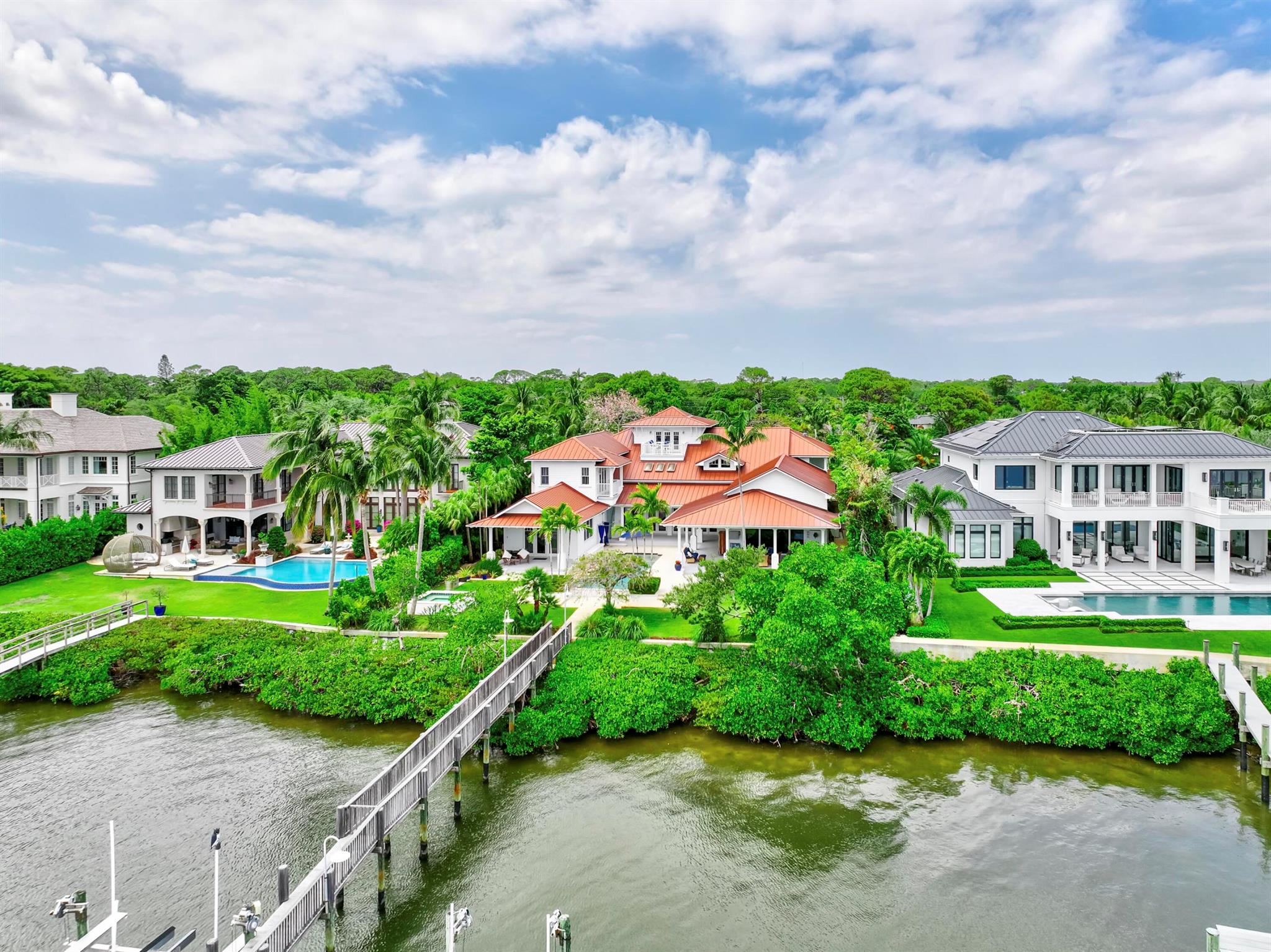 Exclusive waterfront living. Live like a pro in this luxurious waterfront home offered for lease. More photos coming soon.  Welcome to your dream escape! This stunning furnished home on the Loxahatchee River in picturesque Jupiter, Florida, is the epitome of coastal elegance and charm. Designed with a light and bright ambiance, this residence offers an inviting blend of sophistication and relaxation, perfect for those seeking a serene retreat.Step inside to discover elegant, coastal-inspired interiors featuring open-concept living spaces with wide panoramic views of the sparkling river. Expansive windows flood the home with natural light, showcasing the breathtaking scenery and creating a seamless indoor-outdoor flow. The thoughtfully curated furnishings exude modern coastal charm, with soft neutral tones, natural textures, and subtle pops of seaside blues and greens. The fully equipped chef's kitchen boasts top-of-the-line appliances and ample space for entertaining, while the living and dining areas open to spacious outdoor terraces where you can soak in the tranquil river vistas.
Unwind in the luxurious primary suite, complete with private balcony access and spa-inspired ensuite bath. Additional guest rooms provide comfort and privacy, each beautifully appointed for your guests' enjoyment. Your family and guests will spend endless hours in the nicely equipped billiard and game room.
Outside, the property offers direct water access, perfect for boating, paddleboarding, or simply enjoying the peaceful setting. Lounge on the sun-drenched deck, entertain by the waterfront, or take in the evening sunset from 2 private docks, one which accommodates a vessel size up to 40 ft and 20,000 pounds with a 3 ft draw at high tide, the smaller lift holds up to 10,000 pounds and a 24-foot boat. Enjoy the sweeping views of the Loxahatchee River that extend over a mile to the Jupiter Lighthouse.
Conveniently located near Jupiter's best dining, shopping, and beaches, this luxurious rental is a true gem, offering the perfect blend of relaxation and lifestyle.
 Nestled on nearly an acre lot, this 5-bedroom, 7-bath masterpiece offers everything you need to live, entertain, and relax in style.
This 3-story Florida Cracker-style home, designed to modern specifications, boasts an end-of-point location facing SSE, ensuring refreshing summer breezes and breathtaking, mile-long views of the Loxahatchee River.
Property Highlights:
" Elevator for seamless access to second floor
" 3rd-floor widow's walk with panoramic views 
" Anderson windows providing abundant natural light
" Gipcrete layer between floors for added comfort and privacy
" 4-car air-conditioned garage
" Game room with billiards table for entertainment
" Adequate space for a hitting bay in garage for the enthusiast
"       Complete gym with pull-up bar, treadmill, rogue bike and a 
         rower
"        Putting Green
"        Firepit
Outdoor living is redefined with ample space for enjoying the waterfront setting, all while being surrounded by the beauty of Pennock Point. Whether you're looking for an annual or seasonal rental, this home offers the perfect balance of coastal charm and modern luxury.
Schedule your private tour today and step into the lifestyle you've been dreaming of!