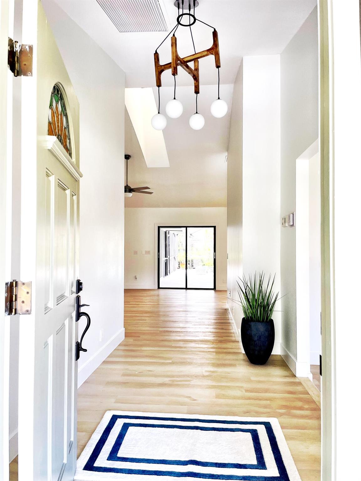 Priced reduced for speedy sale. Rare opportunity to own in the hidden gem of SHADY LAKES! (large lots, unmatched location & low HOA) Rarer still to own the model home on an oversized 1/3 acre, lakefront, corner lot. This 3/2, pool home was TOTALLY REMODELED IN 2025, sunny & bright, soaring ceilings & skylights, new, open kitchen w/ exotic stone, gas stove, hybrid flooring, multiple eating & sitting areas; new bathrooms w/ marble & natural woods; 6 sets of glass sliders open entire home to the newly screened porch with saltwater pool & lake views; Split floorplan, cabana door, NEW ROOF in 2024, new whole house water filtration, full hurricane protection!; Walk to Fresh Market, fine dining, & nationally recognized tennis/pickleball center. Resort living in the best neighborhood in PBG: Home Details

-New Roof and skylights in 2024, flat cement tiles with upgraded foam vs. nail installation. Zero nail holes, which can be a source of leaks (approx. $60K), full warranty with premier local roofer

-Total hurricane protection, full insurance benefit, kevlar fabric panels, easy install, allows enclosing the porch without moving patio furniture

-New Whole House filtration system and Reverse Osmosis for the sink and refrigerator-- clean, safe water from every faucet and water source

-New high-end Flooring throughout, hybrid limestone/LVP material, soft on the body but virtually indestructible for traffic and pets, waterproof, and independently FloorScore-« certified by a US-based third party for low VOC, makes pool/beach living effortless

-Totally New Kitchen with high-level, rare patterned, granite counters, wood cabinets, UPPER and lower cabinet lighting, new high-end appliances, gas range, workspace kitchen sink with built in drying rack and colander, new plumbing and valves

- New upgraded tall craftsman base molding and trim throughout

-All new light fixtures, fans, outlets, switches, door handles, and locks

-Newer A/C continually serviced and maintained

-Professionally landscaped, full sprinkler system and automatic drip lines installed on back patio, never have to water a potted plant

-Brand new pool screens with a 5-year warranty for any tears or storm damage

-Salt water pool, with newer salt chlorinator, virtually maintenance-free and gentler on skin

-Spacious laundry room with ample additional storage and counter space

-2-car garage, with storm door, workbench and unpainted cement floors, ready for epoxy or painting, depending on preference

-Brand new, Extra tall, specialty Carrara Marble primary shower with frameless door

-Brand new guest bath, with no permanent installation or drill holes for the curtain, to allow for a glass door or permanent curtain, as families with young children can find glass doors a burden for baths

-Newly painted throughout, Benjamin Moore high-grade paint in Chantilly Lace

-  Attic access through pull-down stairs in garage, provides additional long-term storage

- Oversized 1/3 of an Acre lot in prime Palm Beach Gardens, walk-to-everything location, rare find

- Timber Trace Elementary is 10/10, according to Great Schools