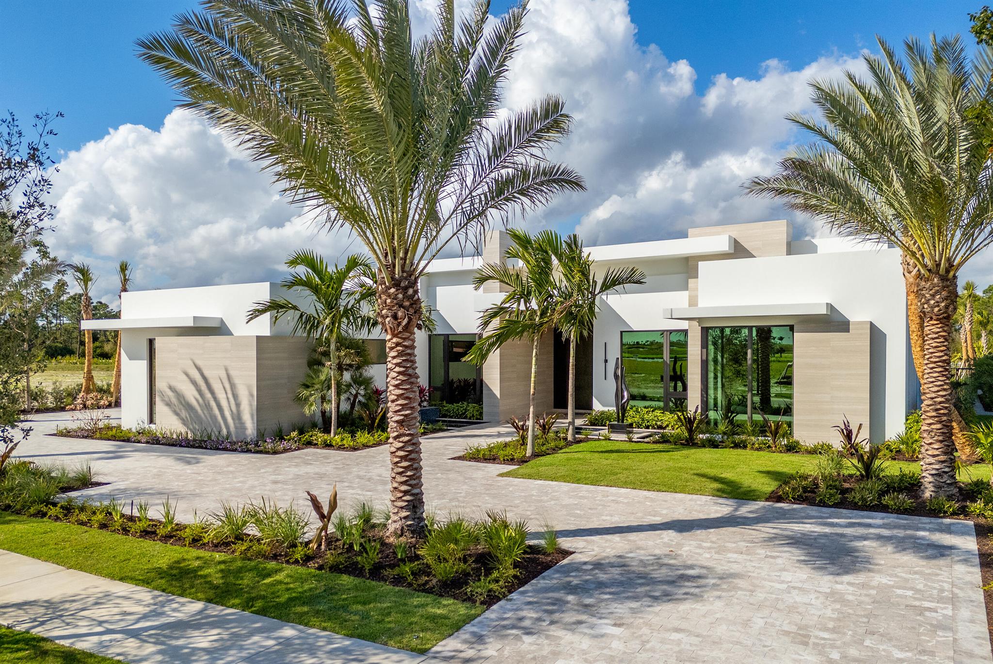 Welcome to the Portrush Model, an architectural masterpiece by renowned Ellish Builders. This move-in-ready contemporary home sits on a 1/2-acre lot in the prestigious Panther National golf community, seamlessly blending luxury and modern sophistication.