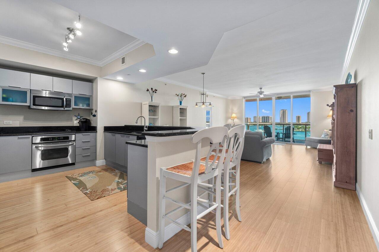 BEST VALUE/PRICED TO SELL TRUE 3/3 in Desirable Ocean Tower - Immaculate 7th floor 3/3 unit with stunning waterfront Intracoastal & ocean views! Featuring genuine bamboo floors in pristine condition! ALL impact glass! Semi-private elevator access, open concept, split floor plan. Spacious owner's suite w/his & her walk-in closets. Primary bath w/double vanity, jetted bath & water closet. New A/C (2022) & stainless steel appliances in the open kitchen. Assigned garage parking & climate-controlled storage unit. 24/7 manned gate, valet, NEW tennis, NEW pickleball & bocce, walking path w/gazebo, newly renovated rooftop oasis w/pool, spa, BBQ areas, clubhouse, billiard room & fitness center. Marina w/dry docks available. Pet Friendly Community. Ready to move right in & enjoy the amazing view!