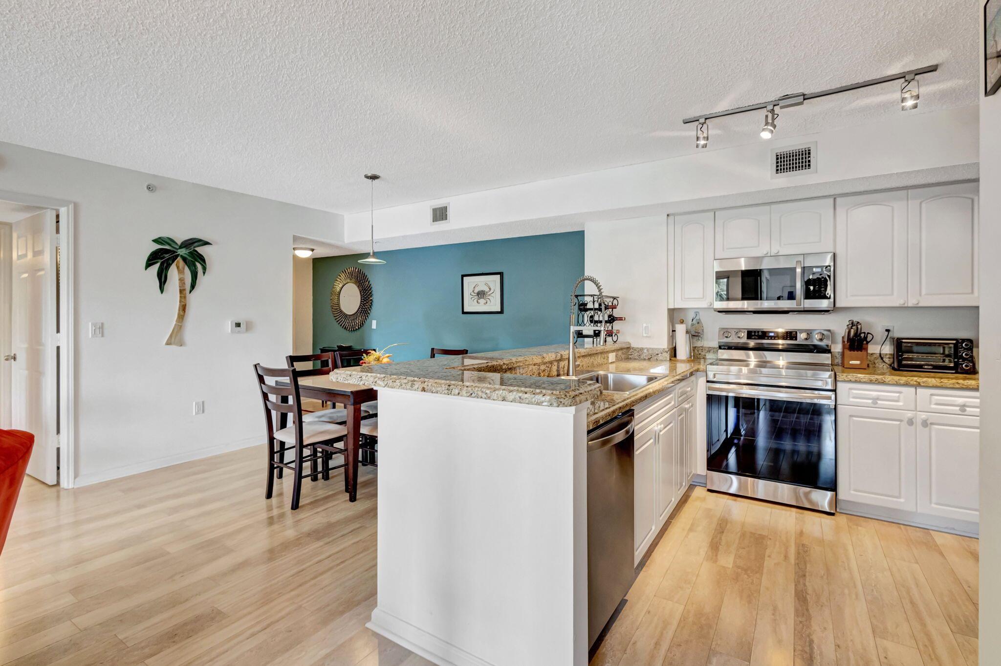 Resort Style Living At Lighthouse Cove. Enjoy The Heated Pool, Fitness Center, Tennis, Pickleball, Volleyball, Grills, Indoor Racquetball, Billiards & Clubhouse. A Few Minute Drive To Jupiter Beaches & Waterfront Restaurants.  This Home Has Been Updated With New Appliances (2024), New Flooring, Updated Bathrooms, & Full Accordion Shutters. New Roofs Were Installed in 2022.  Walk to Starbucks, Grocery Store, Restaurants & Shops.  Enjoy The Easy Drive North On US1 To Hobe Sound Or South To Palm Beach Gardens.  Two Assigned Parking Spots & Plenty Of Guest Parking. 2 Pets Under 45 lbs Are Allowed. Minutes From Jupiter Ocean & Raquet Club, Heritage Golf Club, Jupiter Dunes Golf & North Palm Beach Tennis & Golf.  All Located Off of US1.