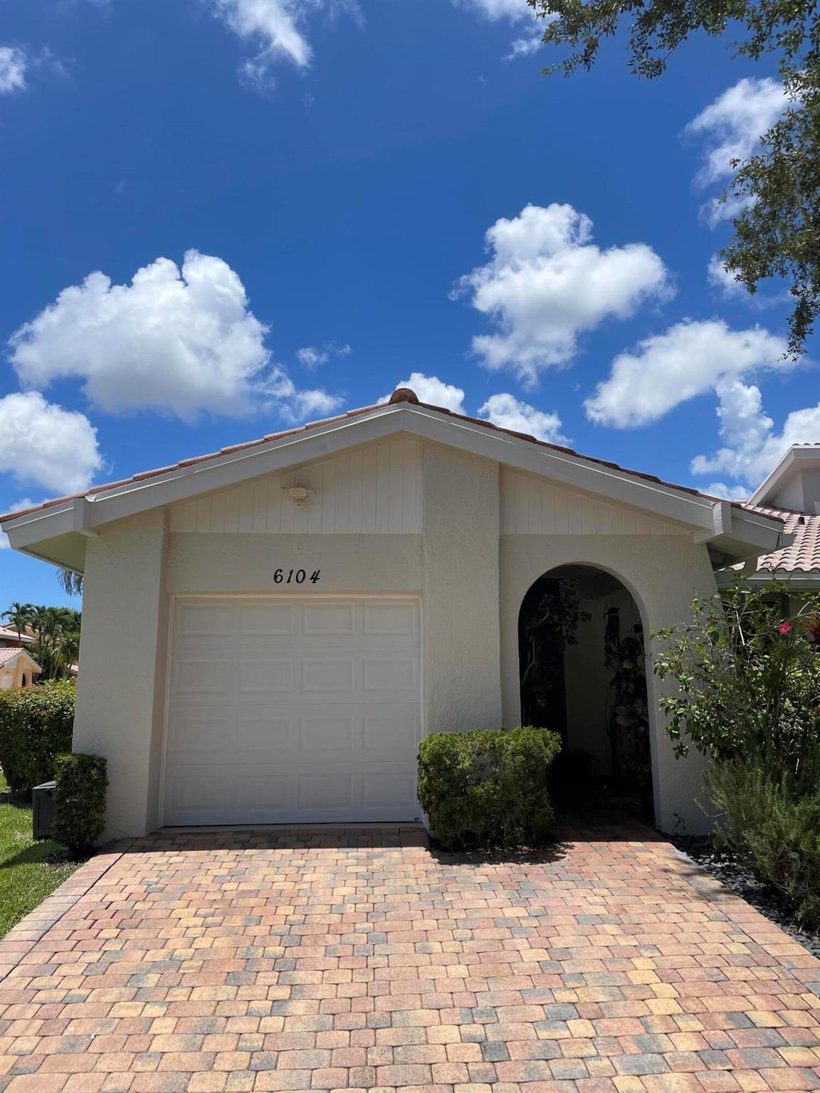 Exterior freshly painted, end-unit on large lot, 3 bed villa located in central Boca Raton near I-95, Turnpike.Walk across street to Town Center Mall & Boca Raton's new Restaurant Row. Excellent on-site mgmt, lakefront swimming pool, gated entrance & more...tiled floors throughout, vaulted ceilings, LED lights, large screened in private oversized patio & two more patio/BBQ areas for true outdoor living, updated bathrooms & kitchen w/ newer fridge, DW & micro, 2020 Rheem 50 gal. HWH system, 2018 Carrier AC, new Amarr hurricane garage door & 2 car pavered driveway. 2025 whirlpool dryer. Lots of light! Paved walkway w lush landscaping ,w/ Zen rock garden & bonsai trees. Storage units + deep freezer in garage. HOA includes: ext paint, landscape & sprinklers, Leasing ok, 1x annual per assoc.