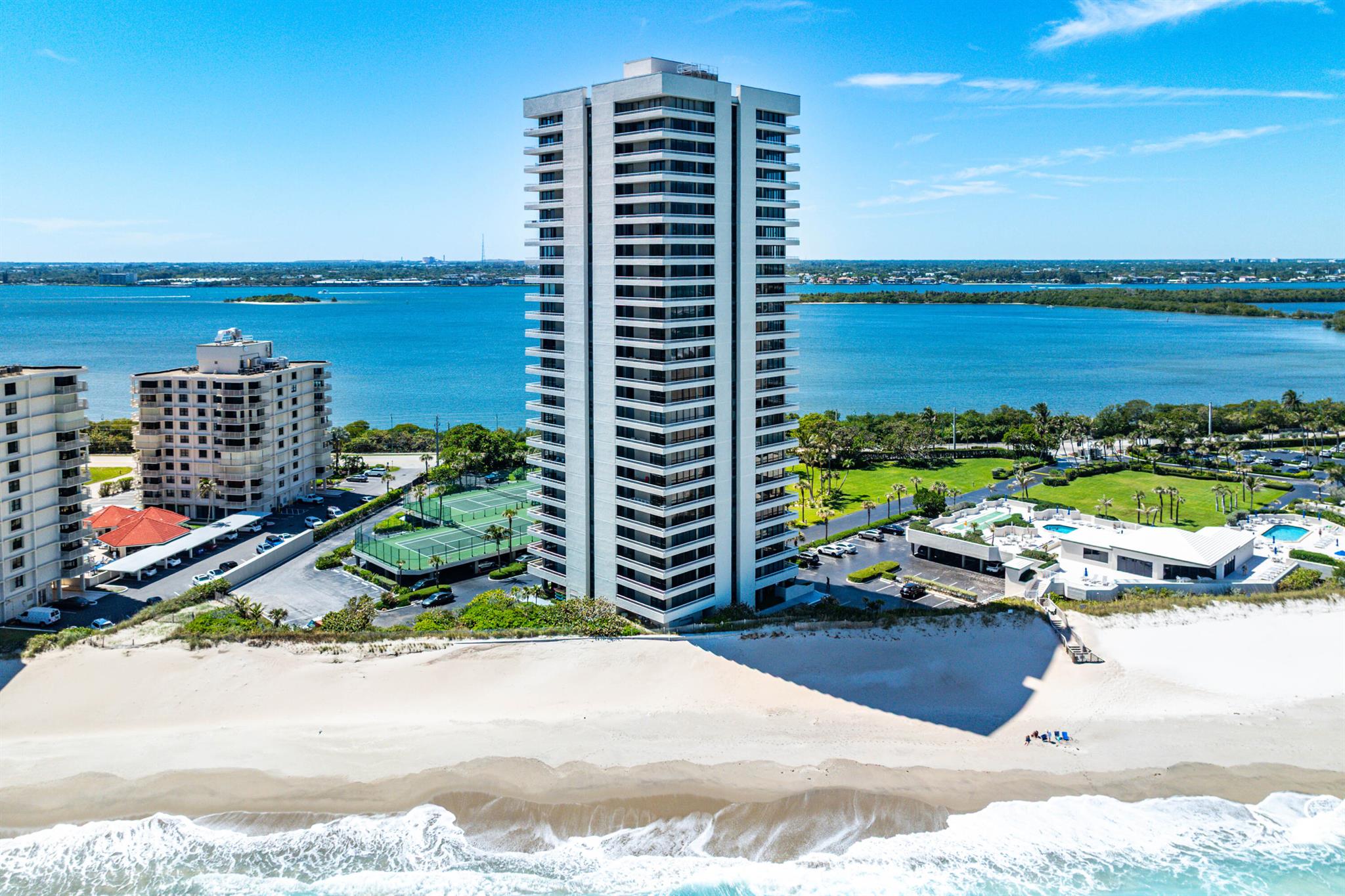 Experience unparalleled luxury in this stunning 2-bedroom, 2-bathroom direct oceanfront condo on prestigious Singer Island. Bask in breathtaking panoramic views through massive windows that flood the space with natural light. The modern white kitchen, complete with stainless steel appliances, is a chef's dream. Both bathrooms have been tastefully updated, adding to the sophisticated charm. Step onto the expansive wraparound balcony, where you'll enjoy unobstructed ocean vistas and sweeping intercoastal views, towering above neighboring buildings. This meticulously maintained building boasts recent upgrades, including a stylishly renovated lobby, state-of-the-art gym, serene library, and refreshed hallways. The spacious clubhouse offers spectacular views of the beach and ocean,
