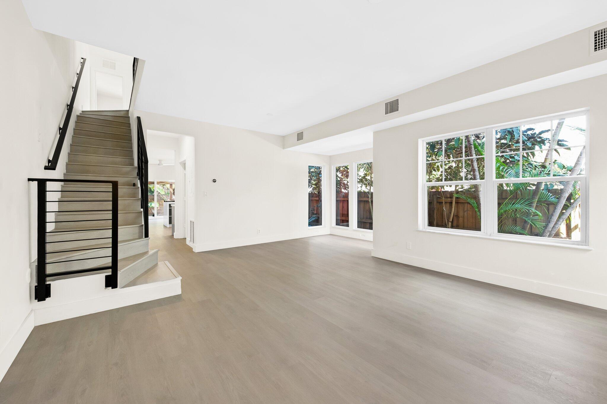Looking for the perfect townhome in a prime location? This is it! Directly across from FAT Village's upcoming development and a short walk to Flagler Village and Downtown Fort Lauderdale, this corner townhome offers incredible convenience and investment potential. The first-floor living area is an entertainer's dream with two spacious living areas, floor-to-ceiling windows, and impact glass sliding doors. The remodeled kitchen boasts sleek quartz countertops and matte cabinets. Upstairs features a versatile den/office, a main bedroom with custom closets, and new baths. Enjoy a spacious backyard, smart home features, and a detached garage. Minutes from the beach, Hard Rock, Brightline, and more!