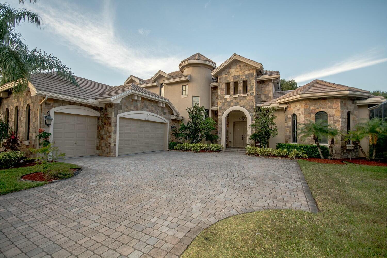 This custom home in the heart of wellington will not last. A+ rated school, close to shopping, restaurants, and equestrian amenities and access to local shopping and hospitals. The master is located on the main floor. This CBS home is built with the look and feel of a castle. Upscale community amenities include a clubhouse, jacuzzi hot tub, fitness center, 1/2 basketball court, children's playground, lighted tennis courts, billiard room, media room, heated pool and more. this home is expansive and has ample room to grow and entertain in this magnificent home. The kitchen boast granite counter tops, ample cabinets, and a full bar located right off the kitchen. This home has been meticulously maintained and only has been owned by two ownersAdditional upgrades of this home include, upgra