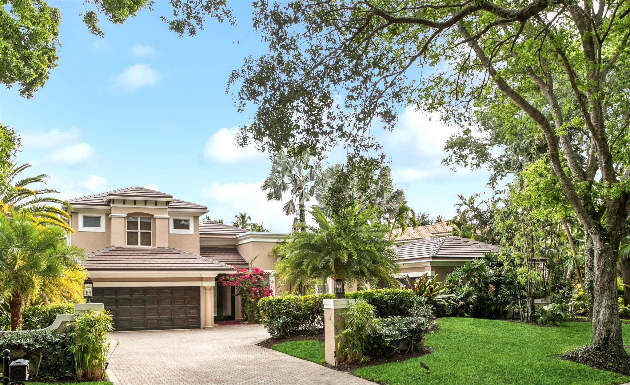 Tropical Serenity Meets Waterfront Living. One of a kind home on 1/2+ acres w/ 85' of navigable water frontage.  Lush, tropical landscaping sets tone of privacy & tranquility. 2-story 4BR, 41/2 BA retreat w/ 4-car garage.  Unique layout designed around expansive, open-air courtyard entry w/ lagoon-style pool, large, cascading waterfall & tiki bar & grille -- a peaceful soundtrack for daily life or entertaining under the stars.Ground floor Primary BR suite. Attached Guest House 4th BR w/ en-suite BA-ideal for visitors, a nanny, or a home office escape.  New Roof.  Tankless water heater. Renovated chef's kitchen features well crafted cabinetry & 8-burner French range & stove.  Rare Social Membership (upgradable).  Experience paradise in Admirals Cove-premier club & waterfront community!