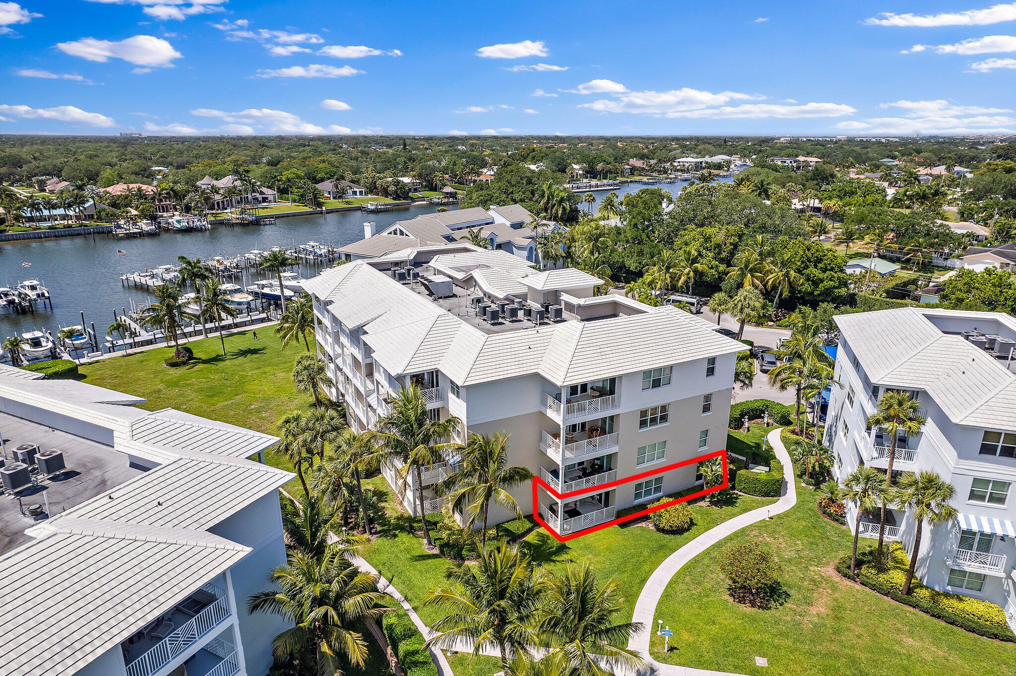 Bring your pets and boat!  Move right into this renovated 1st floor Bay Colony condo with a 40ft boat slip & 9k lbs lift!   Newly built in 2014 with all hurricane impact glass, 9ft ceilings and prime location in Juno Beach.   You'll love the open concept great room with peaceful patio and gate to walk your pets right out to the common area lawn.   Unit 411 comes with one covered parking space very close to the building entrance, a large storage unit and a built-in entertainment center with electric fireplace and mounted TV in family room.   Bay Colony has a resort style pool with fitness center in the clubhouse, tennis/pickleball courts, bbq grills and firepit.  2 pets allowed per residence.  We look forward to showing you this beautiful home, available for purchase without boat slip