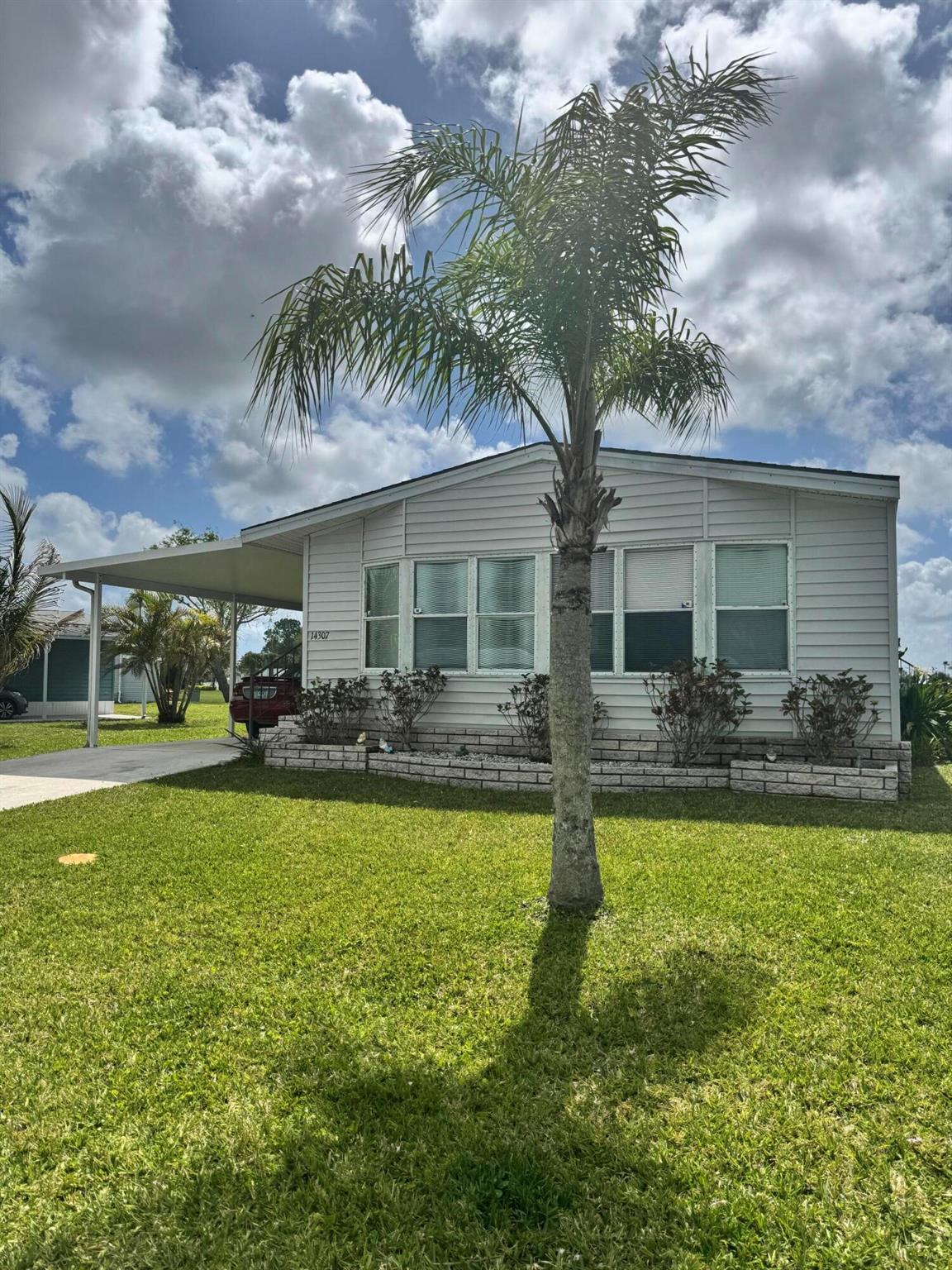 Lovely lake view 2 bedroom 2 bath home in the desirable 55+Spanish Lakes Fairways community. Home is in walking distance to clubhouse. quiet cal da sac. Home has screened lania with sliding windows that is overlooking the lake. Also outside patio area for soaking up the Florida sun. Home has open kitchen and built in shelves in dining area. Bar as well in family room. Laundry room is inside. Primary bedroom has huge walk in closet. Home has oversized shed. Home is being sold Furnished.  Lawn care and trash removal are included in lot rent. 2 pools, tennis, pickleball, bocce ball, shuffleboard, a clubhouse, and much more.