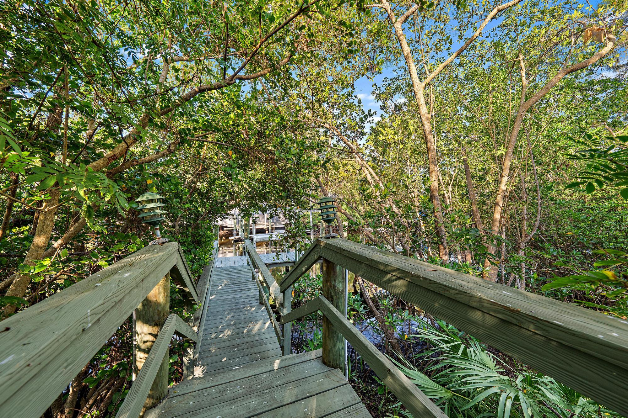 Significant Price Improvement! Recently reduced by $300,000! This Riverfront Luxury Estate on the Loxahatchee River with Ocean Access is now more compelling than ever. Experience the ultimate in waterfront living with this stunning estate on the Northwest Fork of the Loxahatchee River in Jupiter. Offering 5,455 sq ft of living space and 6688 sq ft total on a 3/4-acre lot, this 5 bedroom, 4 full and 2 half-bathroom residence blends elegance, privacy, and convenience. With river views, soaring ceilings, and an open, airy layout, this home is designed for sophisticated living. Step outside to your private tropical paradise, where lush landscaping surrounds a resort-style pool with a dramatic rock waterfall. The outdoor summer kitchen, complete with a full cabana bath and pizza oven creates... provides direct ocean access, with the Jupiter Inlet just minutes away.
A detached flex space with -+ bath offers endless possibilities.&#x14;It can serve as a home office, gym, man cave, home theater or be converted into a two-car garage. Freshly painted, this estate provides a blank canvas for its next owner to customize and make their own.
Ideally located just minutes from I-95 and the Florida Turnpike, this home offers easy access to world-class shopping, dining, beautiful beaches, and the golfing mecca of Palm Beach County. Plus, it's conveniently close to major airports, making travel effortless.
A rare opportunity to own a piece of paradise!&#x14;Schedule your private tour today!