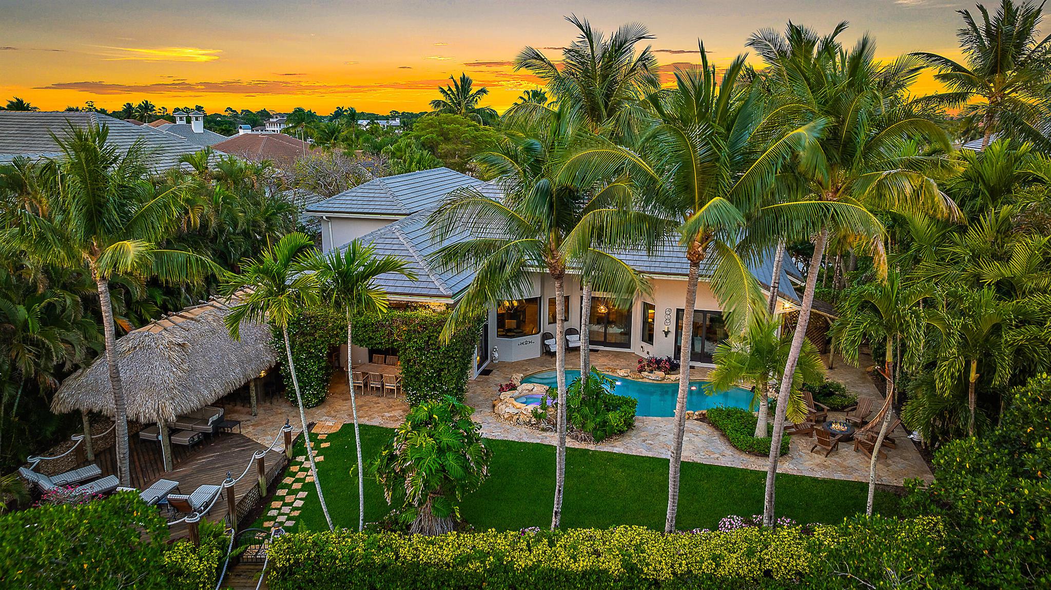 Welcome to your dream home! This beautifully updated property boasts clean lines and modern finishes throughout, creating a light and bright atmosphere that you'll love coming home to. Situated on a prime river location with ocean access, this house offers the best of the Florida Lifestyle.  Backyard with Tiki Bar is ideal for entertaining, complete with a bar and fully equipped summer kitchen. Large windows and open spaces ensure plenty of natural light throughout the home. The kitchen is a chef's delight, featuring custom cabinetry, high-end appliances and elegant countertops.   This is a true gem and a boaters paradise with a private dock.
