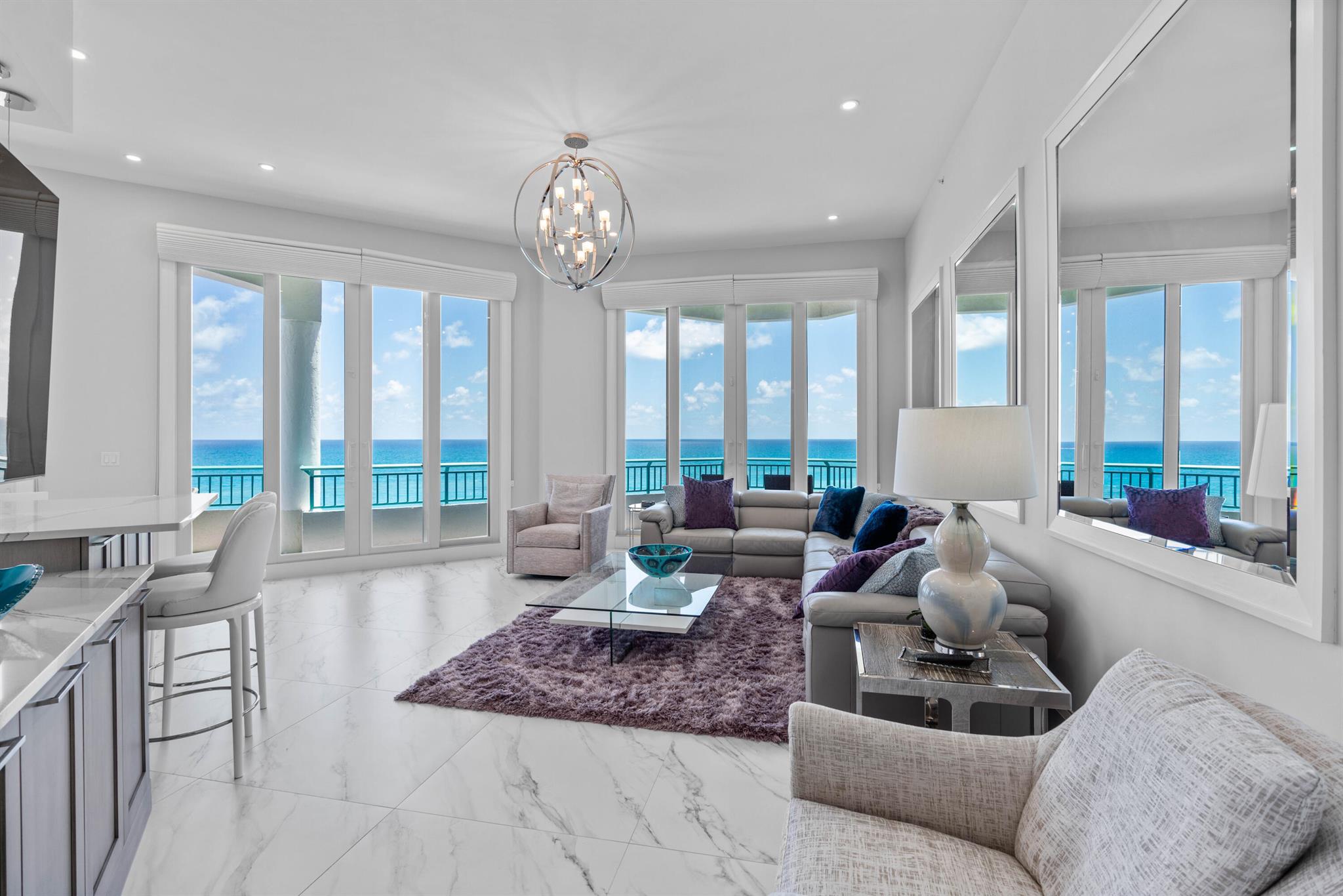 Location, location, location! This fully renovated exquisite Penthouse condo has a dramatic sense of being on a luxury cruise with never-ending, breathtaking views of the blue Atlantic Ocean. The largest Penthouse in the building with soaring 12' ceilings lives like a home. This meticulously professionally designed residence has an open floor plan with all high end finishes, fixtures, Bosch appliances, 36'' porcelain flooring throughout. Impact windows boasting 10 foot sliders and natural light into the condo from every room. Breathtaking views and a built in bar with a very large wrap around private terrace balcony makes this great for entertaining. You will be mesmerized with the extravagant sunrise and sunsets that bring true beauty and pure relaxation immediately upon entering. Ocean Club has very healthy reserves and all studies have been done for Milestone minutes. Boutique, 48 unit building. Simply the best and BETTER than the rest! Additional features include Large air conditioned storage unit and 2 deeded prime parking spaces under building side by side and 2 spaces outside. This Penthouse is truly gorgeous. Resort style living includes a large pool, Clubroom, pool table, BBQ area, gym and sauna. Close to Harbourside featuring restaurants and entertainment. Brand new pool to be completed soon!