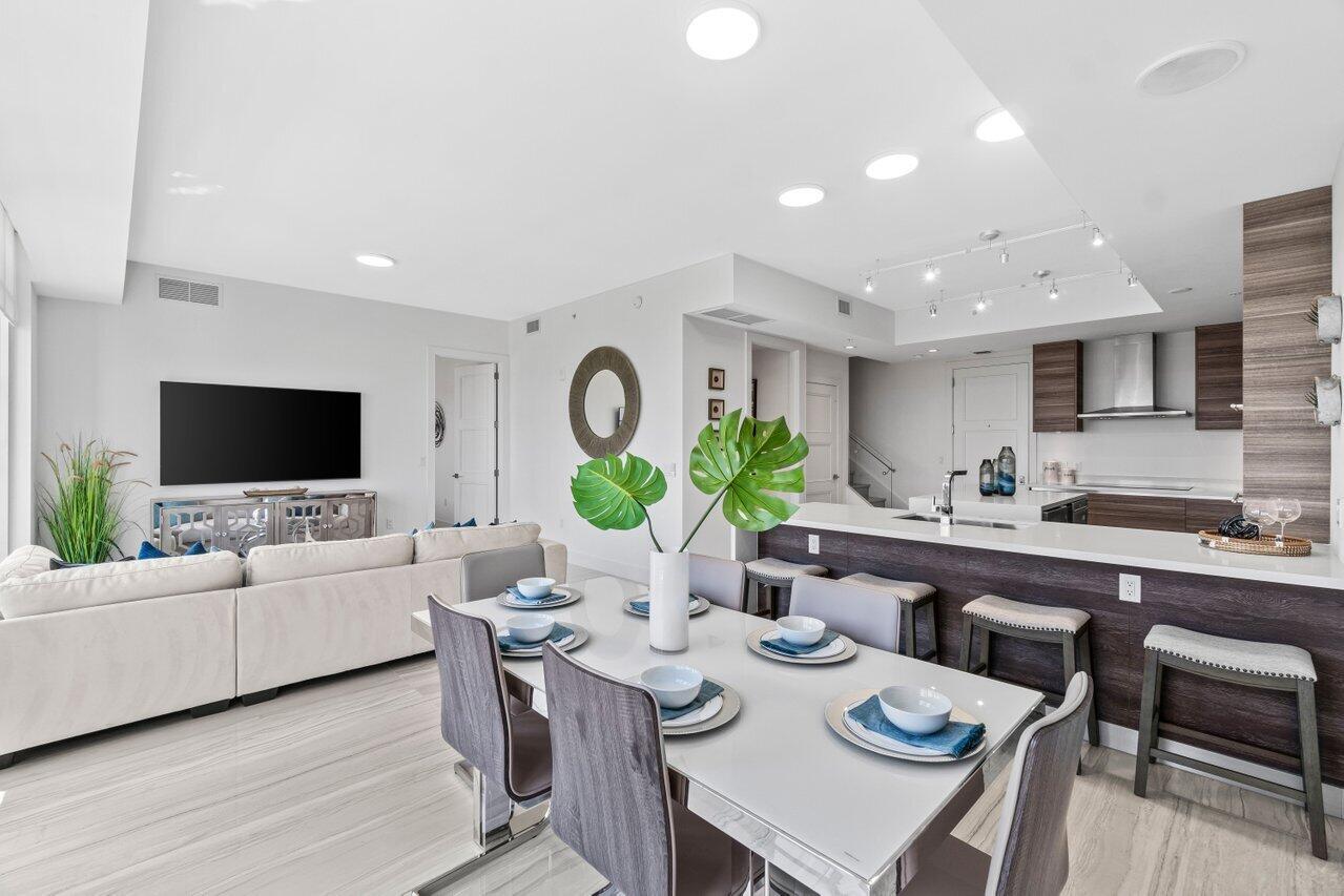 Experience luxury living at its finest in this breathtaking 12th-floor penthouse located in the heart of East Boca. Boasting panoramic ocean and city views, this contemporary furnished 3 bedroom, 3.5-bath residence offers unmatched elegance and style. The master suite is conveniently located on the main floor, providing ultimate privacy & comfort. Floor-to-ceiling windows flood the space with natural light. The chef's kitchen features quartz countertops, Italian cabinetry, Subzero refrigerator, & a spacious center island perfect for entertaining. Steps away from downtown Boca & Mizner Park, this penthouse combines upscale living with unparalleled convenience. Don't miss the opportunity to make this extraordinary residence your own!