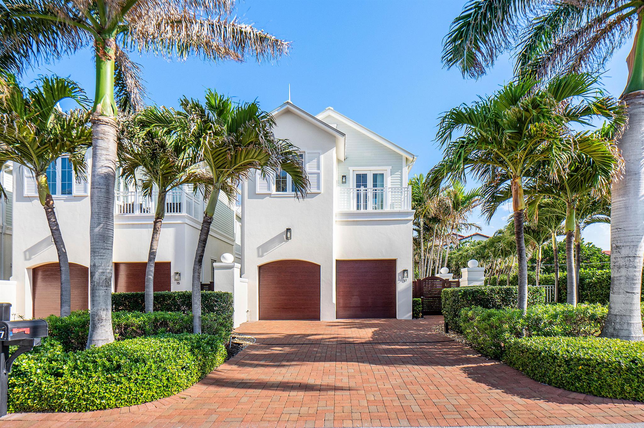 Corner Villa with Ocean Views, Steps from the SandWelcome to 17 Adams Road, a private corner villa in the heart of Ocean Ridge, one of South Florida's most exclusive beachside communities. Just 380 feet from deeded beach access, this luxury 3-bedroom, 3.5-bath residence offers a rare combination of coastal charm, privacy, and modern elegance--highlighted by ocean views from the primary suite.Spanning 2,918 square feet under air, this premier east-facing corner unit lives like a single-family home, offering refined comfort with the convenience of villa living. A three-car garage with hydraulic lift, impact windows, motorized shades, and plans for an optional elevator add everyday ease to this exceptional home. Step inside to a light-filled, open-concept layout that effortlessly connects the kitchen, dining area, and two expansive living spaces&#x14;perfect for entertaining or unwinding in style. A sleek gas fireplace adds warmth and character, while the second living room offers even more space for gatherings or quiet evenings in.

The modern kitchen features premium appliances, a generous island with seating, and ample storage&#x14;all overlooking the main living area and private backyard.

Step outside into a lush tropical retreat, complete with a covered patio, fully equipped summer kitchen (with gas grill, sink, and refrigerator), heated saltwater dipping pool, outdoor shower, and vibrant landscaping that ensures privacy and serenity.

Upstairs, the primary suite offers a true escape, featuring vaulted ceilings, custom wall paneling, a spa-style bath with dual vanities, a walk-in closet with built-ins, and a private balcony with ocean views&#x14;the perfect place to start your day with the sunrise over the Atlantic. Two additional guest suites each include their own ensuite baths and private balconies, ideal for hosting guests in style and comfort.

Built in 2016 with premium coastal-modern finishes&#x14;from wood-look tile flooring to custom millwork and designer touches throughout&#x14;this home offers thoughtful design at every turn.

At 17 Adams Road, you're not just near the beach&#x14;you're living the beach. With private access just steps from your door, every day begins like a vacation.