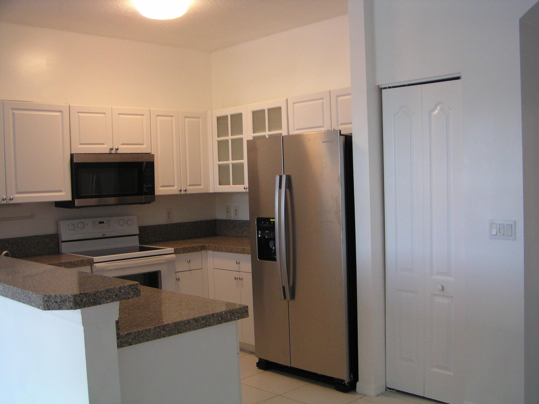Lake Front Townhome in gated community with tile on 1st floor and wood on 2nd floor, stainless steel appliances, washer, dryer, central air, 1 car garage, community pool and children play area. Located behind Costco and water park.