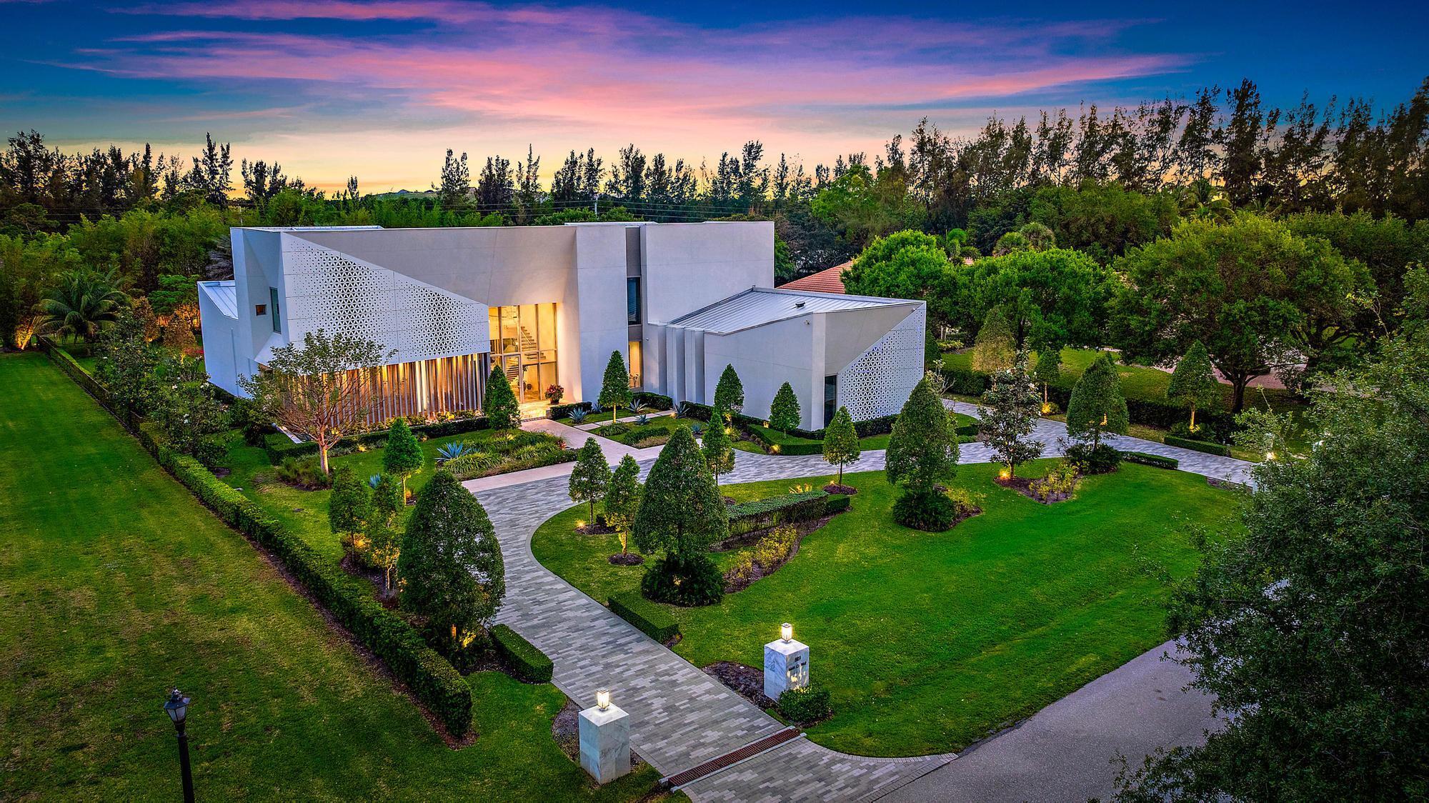 Welcome to this one-of-a-kind modern sanctuary in the heart of Palm Beach Gardens, an ultra-luxury architectural triumph that marries innovation, sophistication and serene beauty!  Spanning 11,144 square feet of living space, this bespoke residence encompasses  five bedrooms, eight bathrooms and two half baths all set against the tranquil backdrop of Japanese-inspired gardens. Meticulously constructed under the direct supervision of the owner, every element reflects the highest standards of modern design and engineering where no detail has been overlooked. Introducing this magnificent residence, the impressive two-story vestibule sets the tone for what lies within, showcasing a glass-suspended staircase, glass-enclosed commercial elevator adorned with an artistic mural finish, and a floor-to-ceiling glass facade that frames views of the exquisitely landscaped front yard. The grand living room is bathed in natural light, crowned by a soaring 25-foot ceiling,  and anchored by a sleek ribbon fireplace set against blue lacquered panels that cleverly conceal media. 10 foot sliding glass doors open to reveal a tranquil oasis with lush gardens and a sun-splashed 75 foot lap pool with spa.

Epitomizing elegance,  the adjoining dining room is equally inviting, with a tray ceiling and serene pool vistas.  For more informal living, the family room flows seamlessly with the kitchen, finished with professional-grade appliances, an expansive butler's pantry, and handsome custom cabinetry with tons of storage that integrates a work island and a floating breakfast bar extension. 

The first-floor primary suite is a peaceful haven, with two walls of glass that open to the pool and gardens. This luxurious retreat comprises his and hers custom-fitted wardrobe closets and dual spa-inspired bathrooms, finished in full marble slabs and fitted with steam showers and Toto bidet toilets. 

Perfectly suited for grand entertaining and everyday indulgence are an indoor/outdoor loggia with summer kitchen, a  fully-equipped gym, two guest suites, library and four-car garage on the first level. Upstairs,  a nine-seat custom theatre and two additional bedroom suites are complemented by a lounge and kitchenette offering comfort and privacy for guests. Additional features throughout include 10 foot ceilings and doors throughout, stainless steel panelized framing, insulated/laminated impact windows throughout, automized shades,  imported rain showers in the bathrooms, flush Italian doors, Smart House/Savant system, whole-house generator with propane tanks, eight-zone air conditioning, and instant hot water heaters. 

DISCLAIMER: Information published or otherwise provided by the listing company and its representatives including but not limited to prices, measurements, square footages, lot sizes, calculations, statistics, and videos are deemed reliable but are not guaranteed and are subject to errors, omissions or changes without notice. All such information should be independently verified by any prospective purchaser or seller. Parties should perform their own due diligence to verify such information prior to a sale or listing. Listing company expressly disclaims any warranty or representation regarding such information. Prices published are either list price, sold price, and/or last asking price. The listing company participates in the Multiple Listing Service and IDX. The properties published as listed and sold are not necessarily exclusive to listing company and may be listed or have sold with other members of the Multiple Listing Service. Transactions where listing company represented both buyers and sellers are calculated as two sales. "No payments made until title passes" Some affiliations may not be applicable to certain geographic areas. If your property is currently listed with another broker, please disregard any solicitation for services. Information published or otherwise provided by seller, listing company or its representatives is deemed reliable but are not guaranteed and subject to errors, omissions, or changes without notice. Copyright 2025 by the listing company. All Rights Reserved.