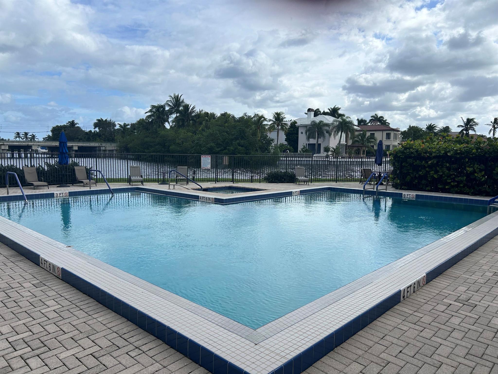 Remodel and design your dream home in a tranquil community on the intercoastal with your own 32-foot boat dock and lift. Nice flooring throughout the area. Walk out your door to steps from the pool and the intercoastal. Great location with only a 5-minute walk to Publix and other shopping and Restaurants.