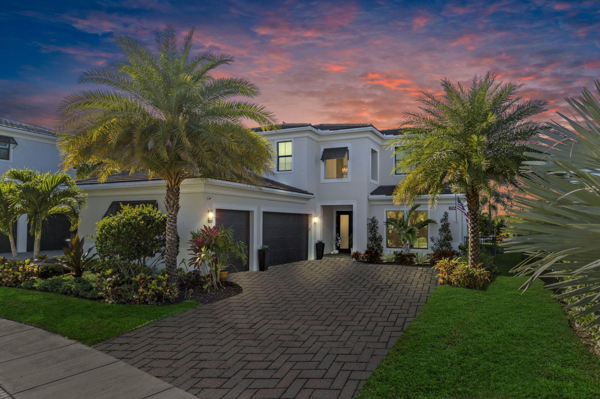 Step into this extraordinary 4-bedroom, 5-bathroom lakefront estate, located in this prestigious Palm Beach County gated community.   Custom-built and professionally designed with entertaining in mind, this luxurious residence seamlessly blends modern elegance with functional living.From the moment you enter, this home makes a bold impression. The main-level entertainment room features a sleek waterfall-edge wet bar with a wine refrigerator, perfect for hosting guests. The open-concept chef's kitchen is the heart of the home, showcasing a striking oversized island, gas range with pot filler, side-by-side refrigerator and freezer, and high-end wall ovens--all designed for  culinary performance and style.The spacious family room is anchored by a dramatic floating staircase and a custom fireplace wall with rich millwork. The first-floor master suite offers a peaceful retreat with dual custom walk-in closets and a spa-inspired bathroom, complete with an oversized shower and double vanities.

 Upstairs, you'll find three generously sized ensuite guest bedrooms, each with walk-in closets, as well as a media loft for unwinding. A first-floor office/den offers flexible space and could easily function as a fifth bedroom.  No expense has been spared, designer upgrades featuring impressive chandeliers, unique wallcoverings and custom window treatments.   
 
Enjoy  the three air-conditioned garages with a fitness room. Outside, the tropical backyard oasis centers around a resort-style pool and spa, a gourmet summer kitchen, and powered screens ideal for enjoying serene lake views in complete comfort and privacy.    

Situated on an oversized lakefront corner lot and surrounded by lush landscaping, this home offers both privacy and space in a vibrant, amenity-rich community.

Community amenities include a state-of-the-art clubhouse, fitness center, resort-style pool with cabanas, indoor/outdoor social space, basketball court, bocce ball, a shaded playground, scenic walking trails, and 24/7 manned gate. Ideally located just minutes from top-rated schools, premier shopping, dining, and beautiful beaches, Artistry combines modern living with an active community atmosphere.