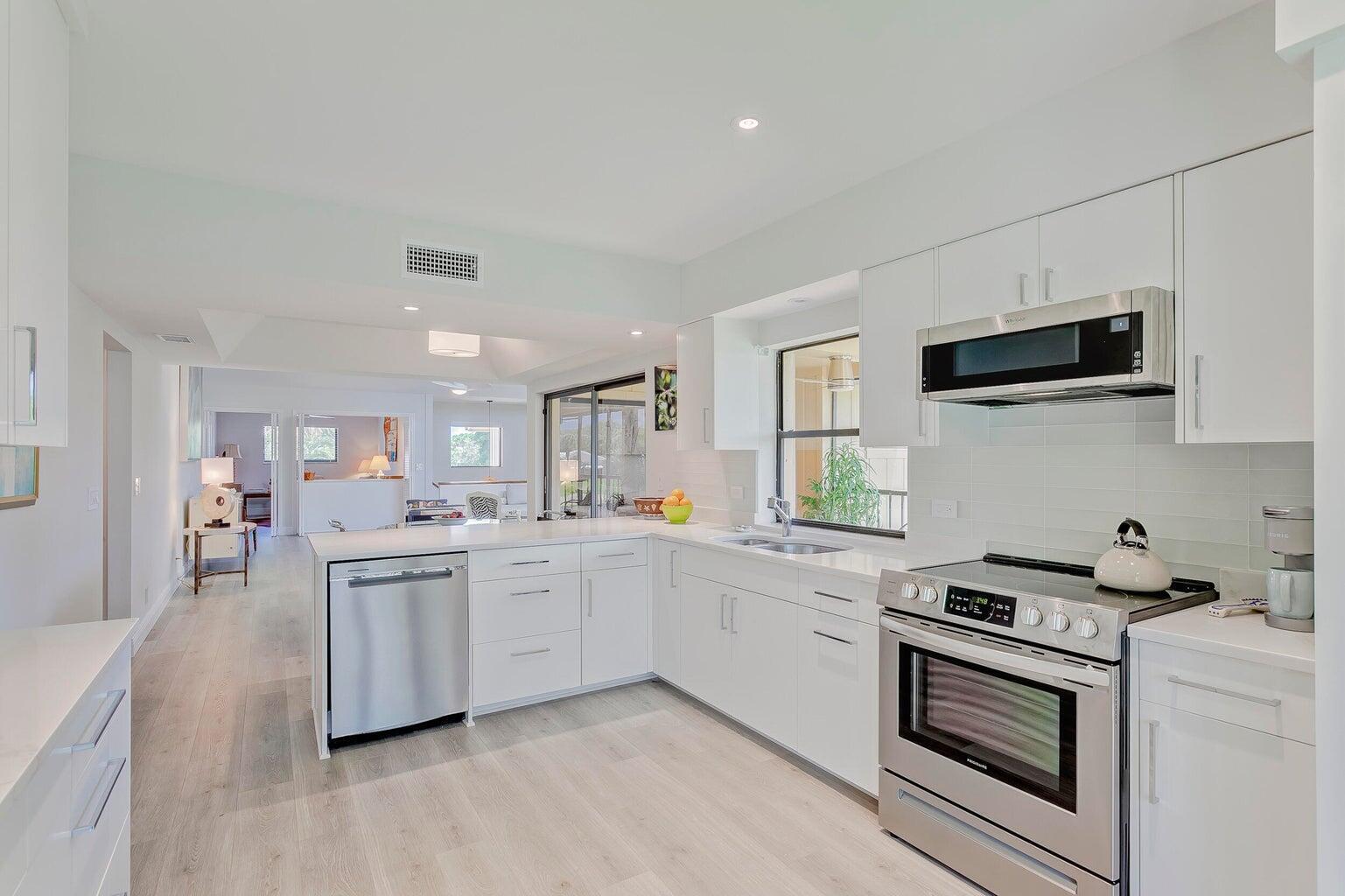 This beautifully updated 2-bedroom, 2-bathroom condo with a versatile den (perfect as a third bedroom or home office) is located in the highly sought-after Waterbend community of Jonathan's Landing. Move-in ready, this home is fresh, clean, and completely renovated from top to bottom.  Enjoy stunning lake views from the open-concept living area, modern kitchen, and cozy screened-in porch--ideal for relaxing or entertaining. The open floor plan enhances the natural light and flow throughout the space. Additional features include a one-car garage and a dedicated golf cart barn for added convenience.Don't miss this rare opportunity to own a renovated, up to date home in one of Jupiter's premier gated communities.