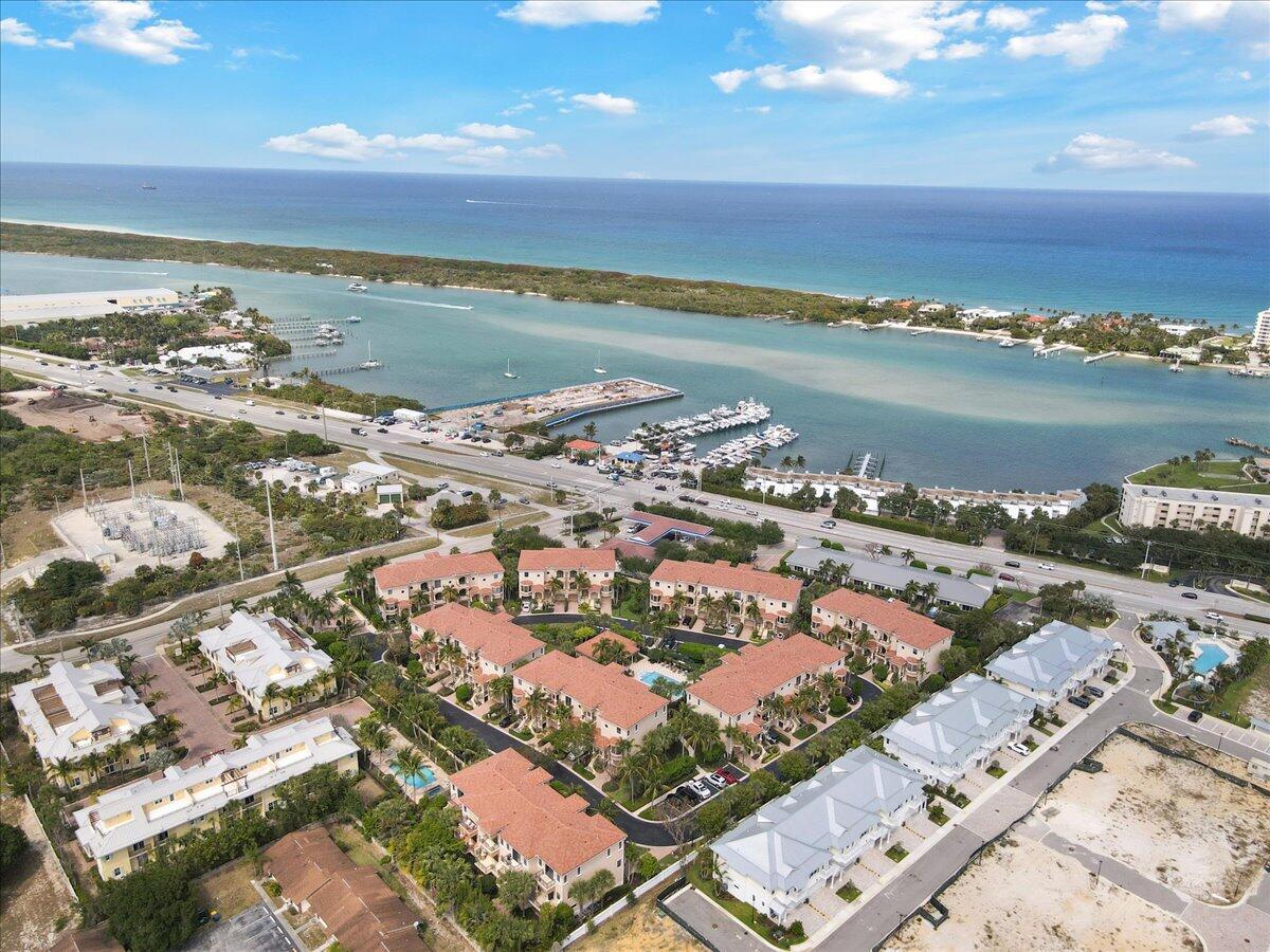 Rare opportunity in one of the area's most unique communities! 3 story split level CBS townhouse with its own private elevator, garage, pool view, impact glass and smart home system, Starlink, and pre-wired for a generator. 3 bedrooms, 3 full baths, half bath, 2 wet bars, dining and breakfast area, 11' ceilings, ground level patio and 3 balconies. Kitchen features stainless appliances and gas stove, Barnwood wall and bar add additional rustic charm. Tesla charger installed and included in sale.Exceptional location on US1 by the intracoastal and all of Tequesta's best shopping and dining. Convenient to Jupiter and Juno's beaches, a short drive to Abacoa, Stuart, West Palm, and an easy ride to 95 and the Turnpike.