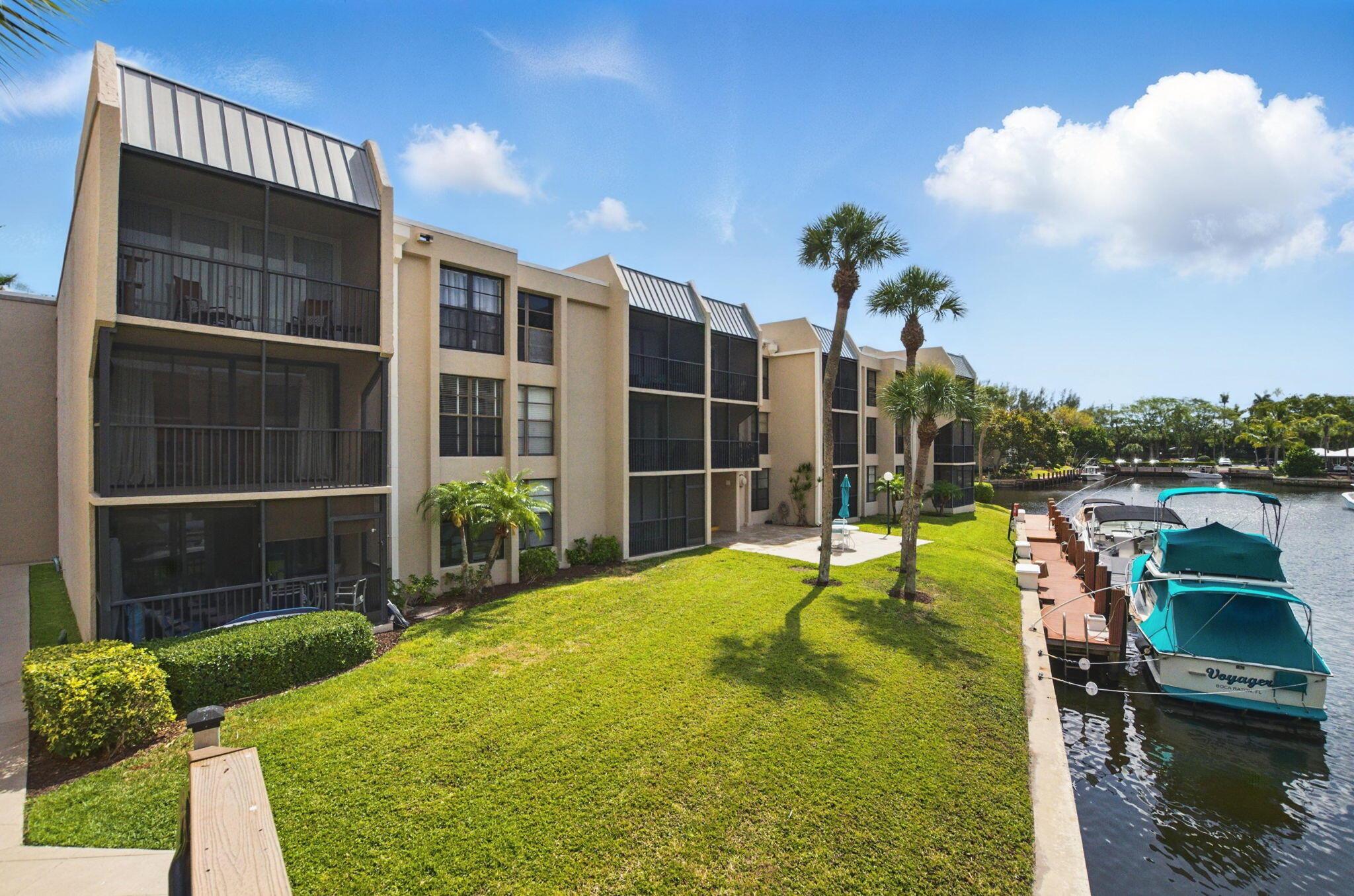 WATERFRONT OASIS IN BOCA! This sought-after split bedroom DELUXE model delivers the perfect balance of privacy and convenience. Features open layout, modern kitchen with wood cabinets, marble counters and SS appliances, updated baths, and NEW A/C. Distinctive upgraded woodwork including wainscoting and panel doors. Relax on your spacious screened balcony with water views. Seller offering $10,000 credit towards upgrades at closing! Steps to one of five heated swimming pools. Amenities include 24hr manned gate, lighted tennis courts, EV charging. Community completed 30-year recertification. All assessments paid. Clubhouse renovation in progress! Maintenance fee covers water/sewer, cable w/HBO, hot water, building insurance. Prime location minutes to beaches, parks, shopping and dining.