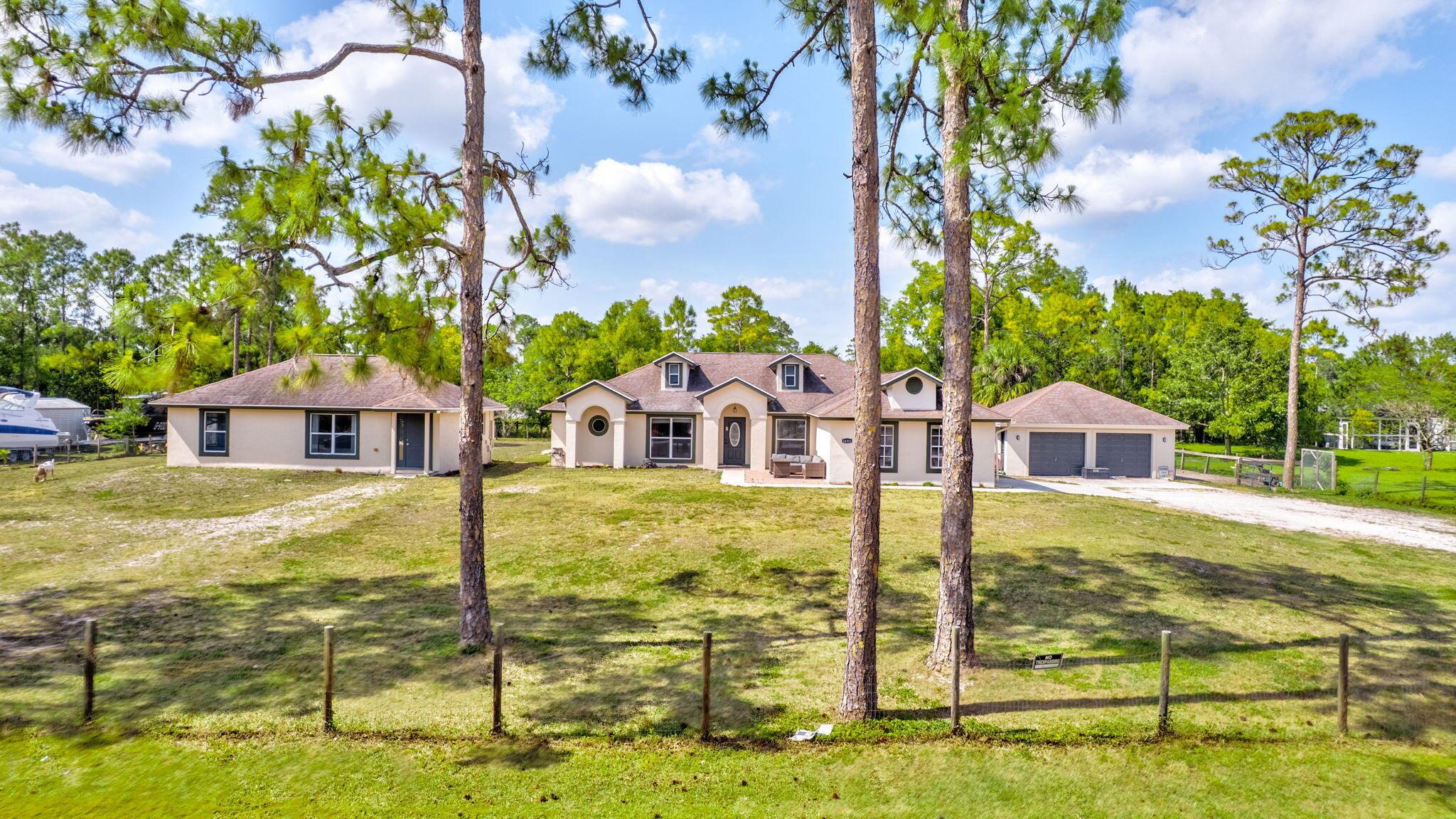 WELCOME TO YOUR DREAM HOME IN THIS COVETED COMMUNITY OF THE ACREAGE!! AGRICULTURAL LAND, 1.3 ACRES. THIS BEAUTIFULLY MAINTAINED SPACIOUS CUSTOM-BUILT HOME FEATURES A 4/2/2 MAIN HOUSE,  A 2/1 GUESTHOUSE, AND A 2.5 CAR DETACHED GARAGE, ALL EXTERIOR NEWLY PAINTED.  HOME SITE HAS 2 WELLS, A BRAND NEW COMPLETE REVERSE OSMOSIS WATER TREATMENT SYSTEM COVERING THE ENTIRE PROPERTY. THE MAIN HOUSE IS TRIPLE SPLIT W/TILED LIVING AREAS, FORMAL L/R AND D/R, UPGRADED NEWER APPLIANCES AND EAT-IN KITCHEN WITH BAY WINDOWS. MASTER BATH HAS DUAL MARBLE SINKS, AND ADA COMPLIANT SHOWER. GUEST HOME IS  PERFECT FOR IN-LAWS, HAS A HUGE KITCHEN WITH FULL SIZE WASHER/DRYER,  TWO BEDROOMS, WITH A  COMFORTABLE SIZE FAMILY ROOM.  BEAUTIFUL POOL AREA IN THE BACKYARD. OWNER IS SELLING A HORSE, GOAT AND CHICKENS, DOES