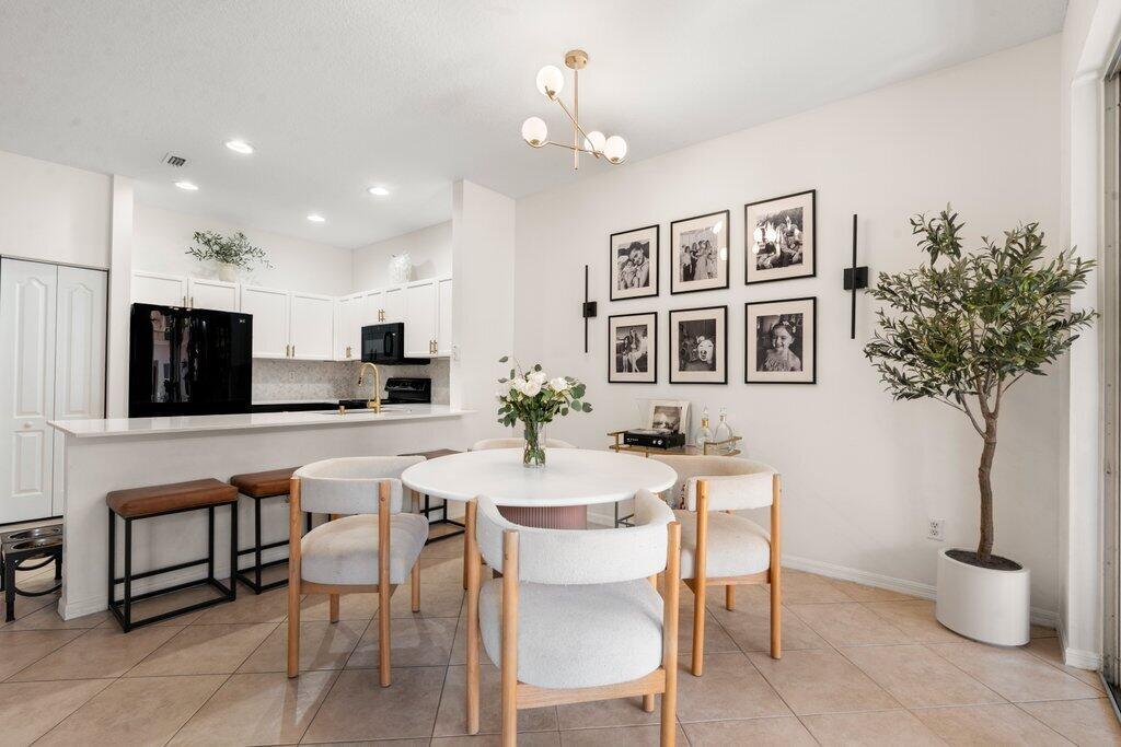 BACK ON THE MARKET! This upgraded townhome offers a spacious open-concept kitchen, living, and dining area with a 1/2 bath, 1 car garage & screened in-patio on the 1st floor. Upstairs features 3 large beds, 2 full baths, & laundry. The primary suite includes a walk-in closet, en-suite bath w/ dual vanities, soaking tub, and walk-in shower. Seminole Lakes Community is an all ages, pet friendly, investor friendly community known for having LOW HOA fees with all the perks- gated, 2 pools, playgrounds, basketball court & walking trails. Less than .5 miles away from Calypso Bay Waterpark, Costco, Starbucks, convenient access to top-rated schools, just 15 mins to PBI Airport. Kitchen remodeled (2023) luxury vinyl flooring upstairs (2024) new garage motor (2022) water heater (2021)
