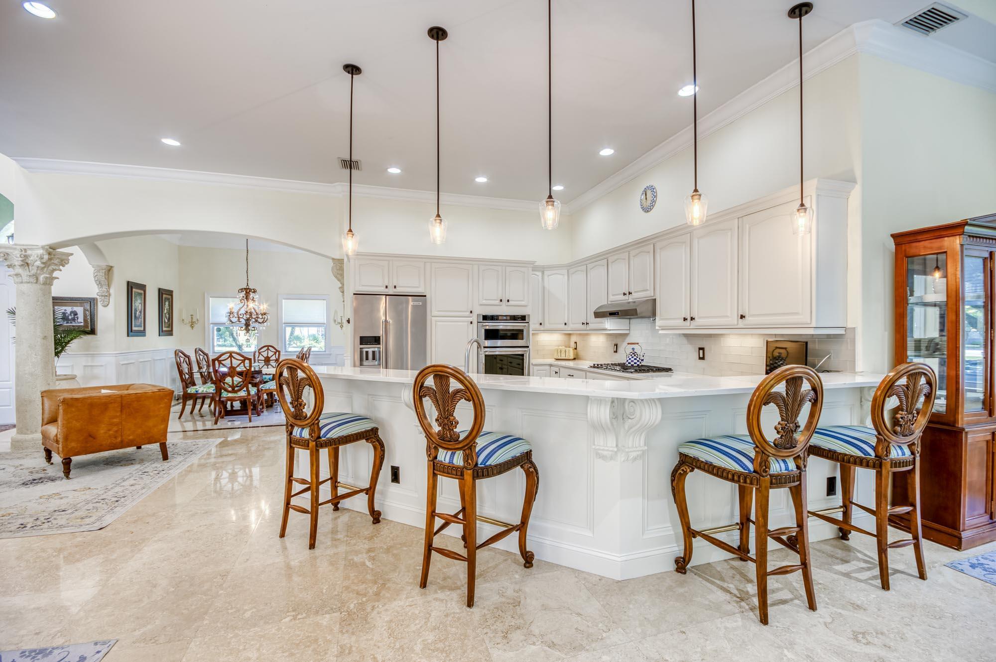 Step inside one of the few true custom homes in Egret Landing thoughtfully designed with a spacious open floor plan and a convenient first-floor primary suite. From the moment you enter, you'll notice the elegant travertine floors, impact windows, and high-end finishes that flow throughout. The updated kitchen is the heart of the home, featuring quartz countertops, white wood cabinets, a gas range with hood, and stainless steel appliances--perfect for everyday living and entertaining. The primary suite offers dual closets with built-ins, a renovated bath with brushed gold hardware, porcelain tile floors and sliding doors that lead to the patio and dip pool with tranquil fountain. Upstairs, you'll find three comfortable guest bedrooms, each with updated flooring for a fresh, modern feel. Two bedrooms feature durable luxury vinyl, while the third is finished with sleek porcelain tile. Outside, enjoy a fenced and low-maintenance turf yard; covered patio with paver pool deck that surrounds a charming dip pool with a tranquil fountain ideal for relaxing. Located in a family-friendly community with low HOA, resort-style amenities, and top-rated schools, all just minutes from Abacoa and Jupiter's beautiful beaches. List of recent updates/ quality finishes: Water heater replaced in December 2019, Water softener installed in April 2020, Air conditioner replaced in August 2020, Dishwasher, gas range, and wall oven/microwave combo updated in November 2021, Kitchen upgraded with new quartz countertops and designer backsplash, Primary bathroom fully renovated with modern finishes, Guest rooms updated with luxury vinyl plank and porcelain tile flooring, Solid wood interior doors, Impact windows.