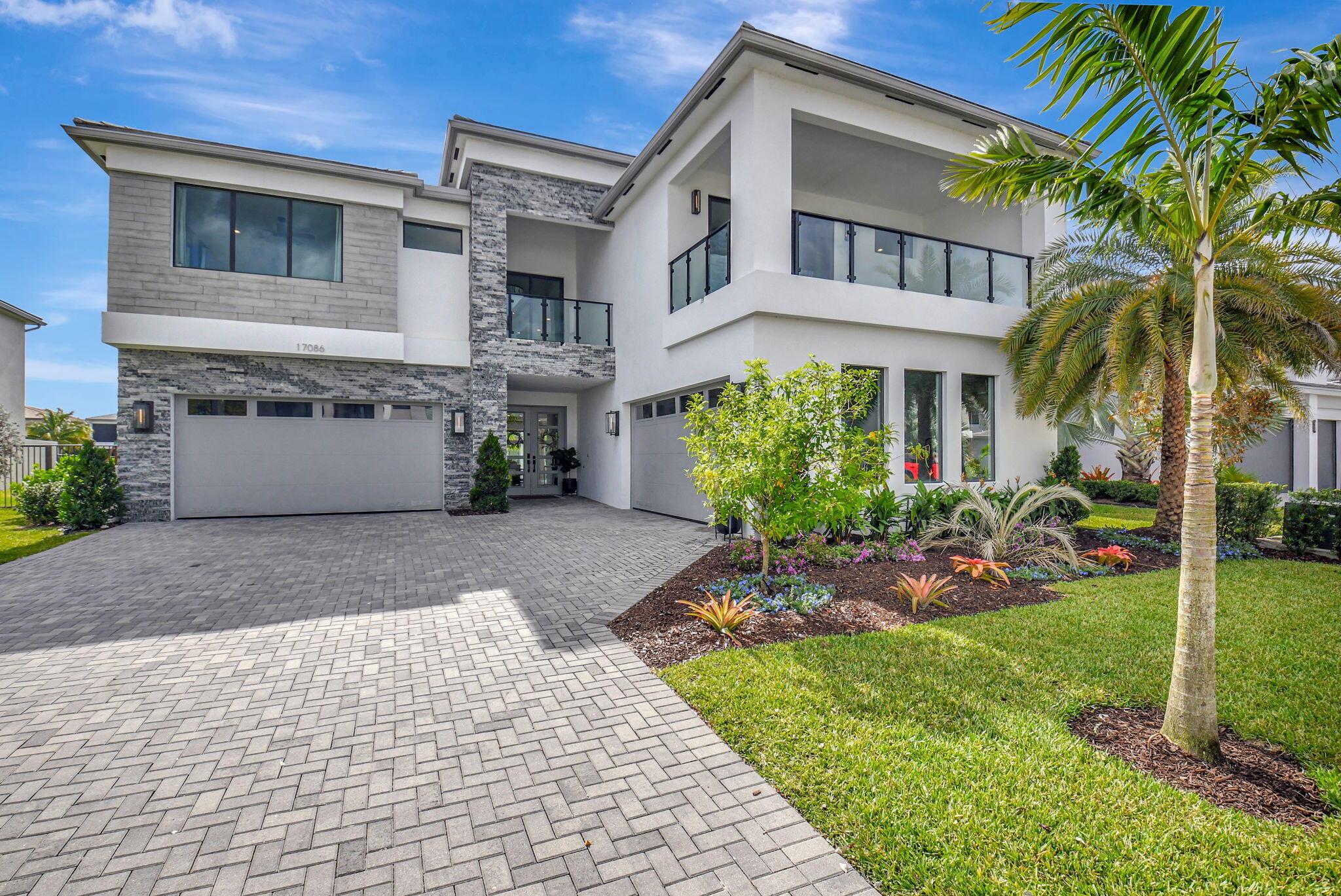 Experience unmatched luxury and design in the largest model home in Lotus, beautifully positioned on a private easement lot with an extra wide yard and  stunning lake views. This 6 bedroom, 7 full and 1 half-bath estate features all ensuite bedrooms, offering the ultimate in comfort and privacy. Step outside to your resort-style pool with child gate and oversized hot tub, perfect for relaxation and entertainment. Inside, discover designer finishes throughout, including Restoration Hardware chandeliers, Modern Forms lighting, 7'' crown molding throughout and gorgeous Porcelanosa tile with herringbone detail in the kitchen. The chef's kitchen is a masterpiece, boasting quartzite countertops, a SubZero fridge, Wolf gas cooktop and oven, two BOSCH dishwashers, and a nugget ice maker capable of producing up to 65 lbs of ice per day. Custom accent walls, Pottery Barn drapes, and a natural color palette enhance the home's luxurious feel. Additional highlights include two 2-car garages, a cabana bath, and a summer kitchen built by the "King of BBQ." Lotus, located in the heart of Boca Raton, offers more than just a home, it offers a lifestyle. This exclusive gated community blends modern living with a vibrant resort-style atmosphere. Residents enjoy access to pools, state-of-the-art fitness centers, tennis and pickleball courts, basketball courts, a splash park, and a private restaurant, all designed to elevate daily life. Landscaping is included, allowing you more time to indulge in everything Lotus and Boca Raton have to offer. Beyond the gates, discover Boca Raton's finest upscale shopping destinations like Town Center at Boca Raton, Mizner Park, and Royal Palm Place. Spend your days enjoying world-class dining, championship golf courses, luxury spas, museums, botanical gardens, and the pristine beaches that make Boca Raton a premier destination. Don't miss the opportunity to live in one of South Florida's most sought-after communities&#x14;schedule your private tour today and experience the luxury lifestyle you deserve!