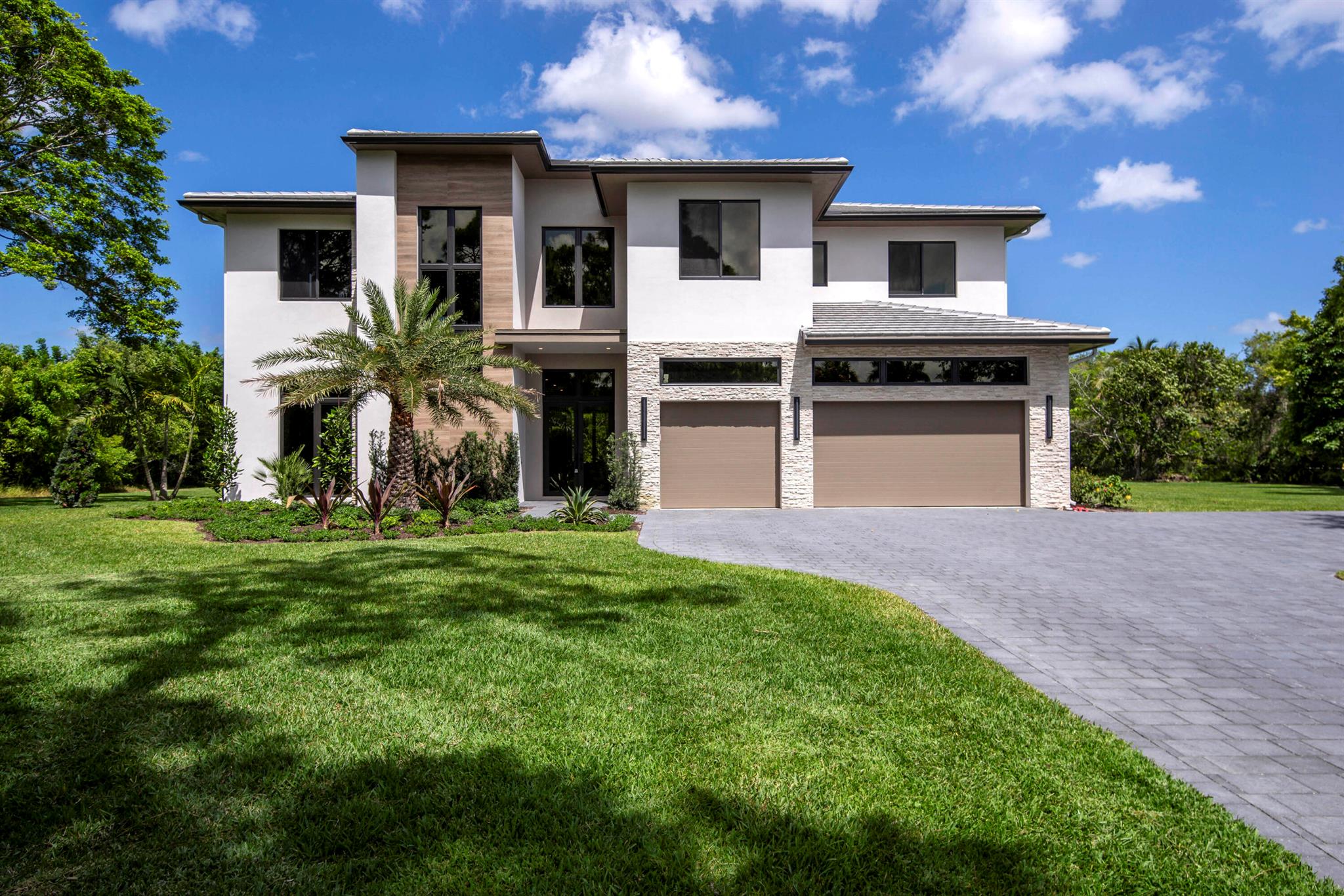 Experience the Height of Modern Elegance. Crafted by Dell Development, this exceptional new construction sits in the prestigious Horseshoe Acres community in the heart of Palm Beach Gardens. Situated on over an acre, this two-story, 5-bedroom, 6.5-bath estate offers 5,400 square feet of thoughtfully designed living space, blending refined style with functional luxury. From the moment you enter, the home's clean lines and open layout make a striking impression. The main living area features European white oak flooring, a sleek stone-surround fireplace with a media wall, and 10-foot floor-to-ceiling sliders that create a seamless indoor-outdoor connection. The chef's kitchen is both beautiful and practical, showcasing a waterfall marble island, matching marble countertops and backsplash, abundant custom cabinetry, and premium Sub-Zero and Wolf appliances. The ground-floor primary suite serves as a private retreat, with dual walk-in closets, a luxurious bathroom featuring a soaking tub, dual showers, and dramatic large-format porcelain tile extending from floor to ceiling. Upstairs, a spacious loft and game room offers added flexibility, alongside well-appointed guest bedrooms with en-suite baths and walk-in closets. Outdoors, enjoy a full summer kitchen, sparkling pool with sun shelf and spa, and lush tropical landscaping&#x14;ideal for entertaining or relaxing in total privacy. This prime Palm Beach Gardens location offers a rare combination of tranquility and convenience, appealing to privacy enthusiasts and luxury homebuyers alike. Come see this extraordinary property for yourself and discover what makes it truly one of a kind.