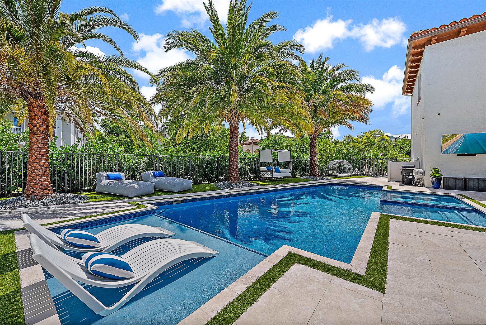 Welcome to 2069 Dickens Terrace, an elegant and spacious residence located on a premium corner lot in Alton, a vibrant community that blends comfort, style, and a true sense of neighborhood. This 4-bedroom, 3 full and 2 half bath home offers nearly 4,000 square feet of thoughtfully designed living space and a resort-style outdoor experience that feels like a private retreat. The backyard is designed for relaxation and fun, featuring a turf putting green, beautiful pool with sunshelf, spa and lush tropical landscaping. Inside, you'll find sophisticated finishes throughout, including amazing fireplaces, eye-catching wine storage that doubles as a design focal point, and upgraded details throughout. The 3-car garage includes a private guest apartment above, perfect for hosting guests, or suiting whatever you may need!
Alton's impressive amenities add to the appeal &#x14; residents enjoy access to a modern fitness center, a kids' activity room, tennis and pickleball courts, a full basketball court, sand volleyball, and a resort-style pool with cabanas, and much more!
Beyond the community, you're just minutes from some of the area's top destinations. Spend weekends playing championship rounds at nearby golf courses like Abacoa Golf Club. Enjoy shopping, dining, and events at Downtown Abacoa, The Gardens Mall, and Harbourside Place. And for those who love the water, Jupiter's pristine beaches, scenic Intracoastal Waterway, and nearby marinas offer a lifestyle filled with paddleboarding, boating, and coastal sunsets.
At 2069 Dickens Terrace, you'll experience a lifestyle that blends everyday luxury with convenience, leisure, and the natural beauty of coastal South Florida.
