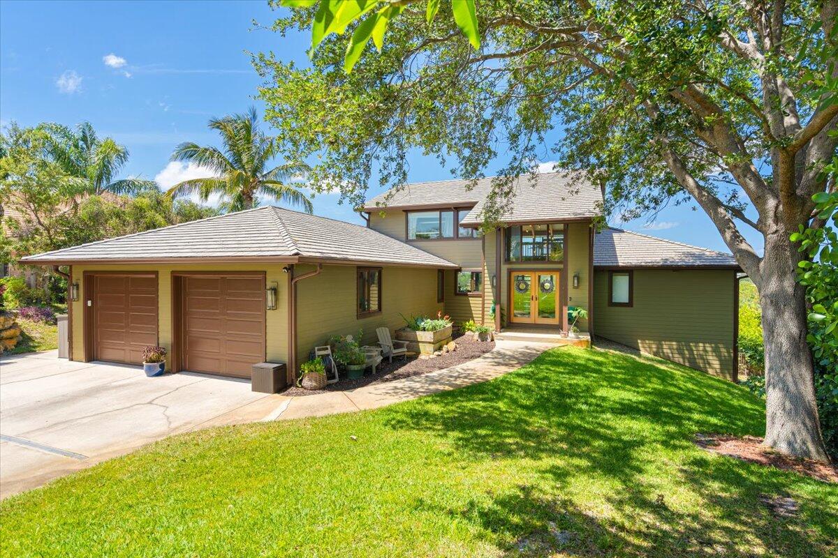 Perched atop one of Florida's highest elevations and offering sweeping views of Henderson's Pond and the Savannas Preserve, this extensively renovated 3-story home boasts 5 bedrooms, 3.5 bathrooms, oversized 2 car garage, set on a lush 0.76-acre lot. This one of a kind home features lofty 21' ceilings, large picturesque windows, exposed Bahamian mahogany beams, slate flooring on the main floor, butcher block island kitchen, a separate in-law floor with kitchenette area and 2 bedrooms, private pool with views, SONOS multi-room 7 channel sound system, and so much more. Residents enjoy low HOA fees, proximity to top-rated schools, and easy access to downtown Jensen Beach and Hutchinson Island beaches. This home is a true gem for those seeking luxury and tranquility.