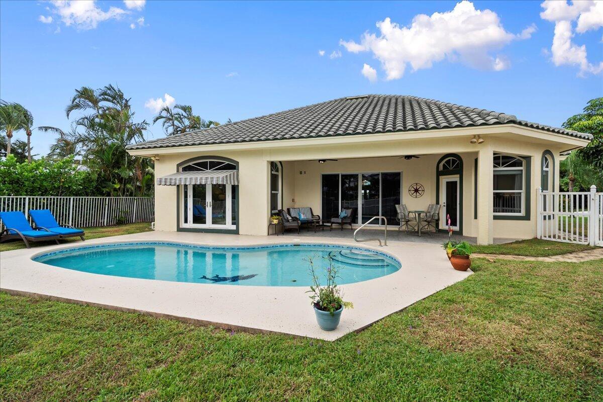 Welcome to waterfront paradise in Jupiter's prestigious Waterway Village! This captivating single-story 3 Bedroom, 2 Bathroom, 2 Car garage single family home epitomizes coastal living. Vibrant island colors and coastal furnishings welcome you into this oasis. Meticulously designed with a split-floor plan, ensuring privacy. The heart of the home lies in the stunning open kitchen, blending style and functionality. Expansive Impact glass windows and doors reveal a private pool and lanai. Outside, discover your very own private lanai and and private boat dock (no lift). Waterway Village residents have access to private neighborhood park along the intracoastal waters, featuring Adirondack chairs, Tiki huts, BBQ grills, kayak launch, and a fishing pier. Indulge in waterfront living