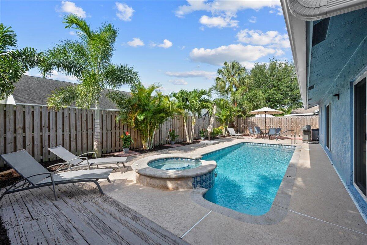 Motivated Seller! This delightful super clean CBS-built home boasts 3 BR, 2 BA with a pool. Major updates like a new roof and gutters in 2023, a fresh A/C and duct system in 2022 plus full house surge protection give you peace of mind & comfort year-round. Impact windows & doors in 2022 along w/ panel shutters for additional protection. The backyard is your own retreat, complete with a heated/cooled salt system pool & spa, ideal for soaking up the Florida sun or enjoying a cool evening dip. Inside is light and bright w/ tile & vinyl floors, the kitchen features shaker style soft close cabinets, granite countertops, high-end Whirlpool stainless steel appliances, including a Bosch dishwasher. Highly desirable neighborhood, no HOA restrictions, minutes to Abacoa, beaches, golf, shops & dinin