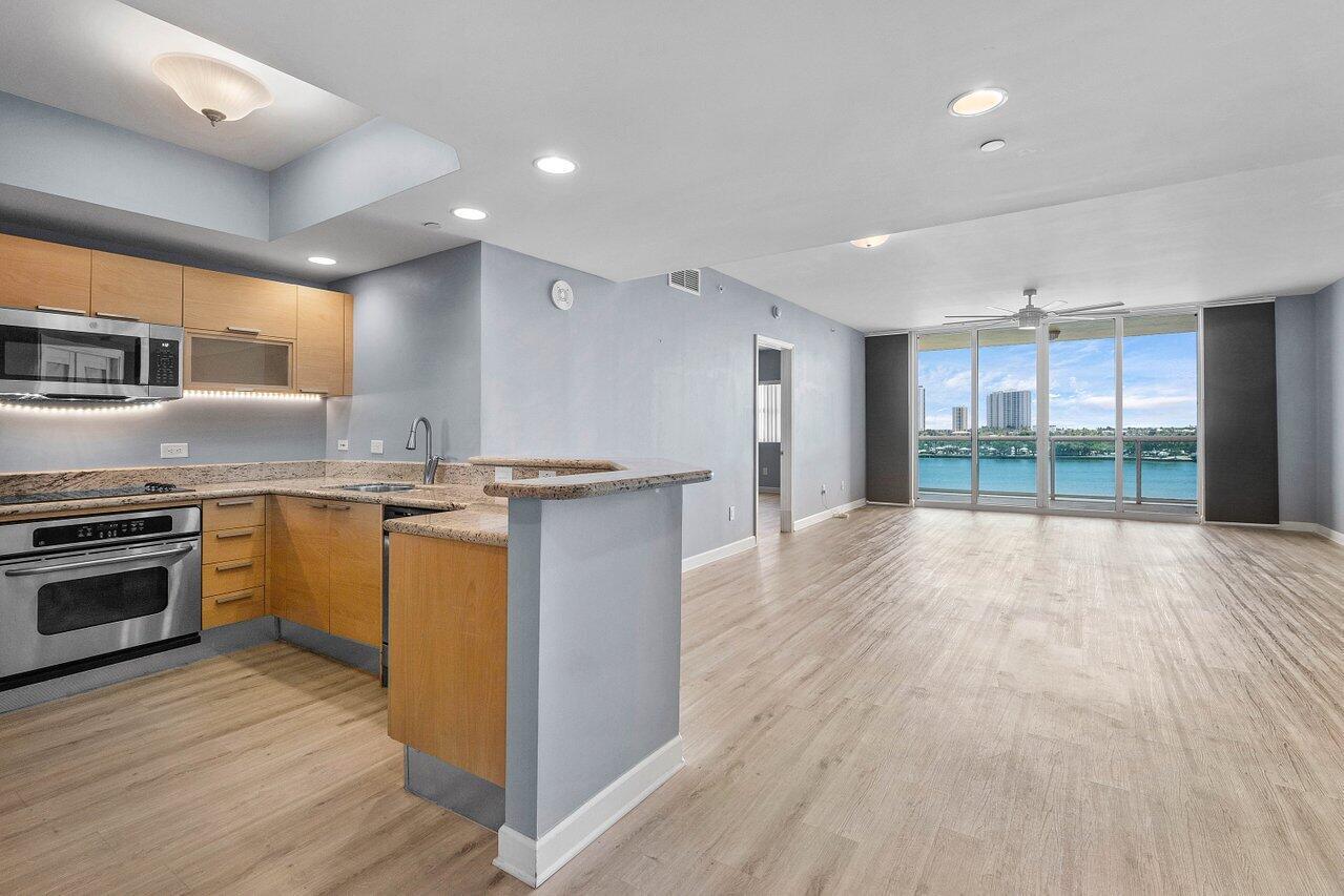 6th floor 2BR + bonus room/den, 2BA condo with east/sunrise views overlooking the Intracoastal. LVT floors throughout (except primary bath), glass enclosed primary shower, a/c under 2 years old, built-ins in all closets. Impact glass, semi-private elevator access. Open concept, neutral colors, split floor plan. Spacious owners suite w/his & her walk-in closets. Primary bath w/double vanity, jetted bath, water closet. Assigned garage parking (close to elevator!) & climate-controlled storage unit. 24/7 manned gate, valet, NEWLY renovated rooftop oasis w/pool, spa, BBQ areas, tennis, pickelball, & bocce. Clubhouse, billiard room & fitness center, walking path w/gazebo, Adjacent marina w/dry docks, minutes to the ocean, no fixed bridges. Pet friendly.