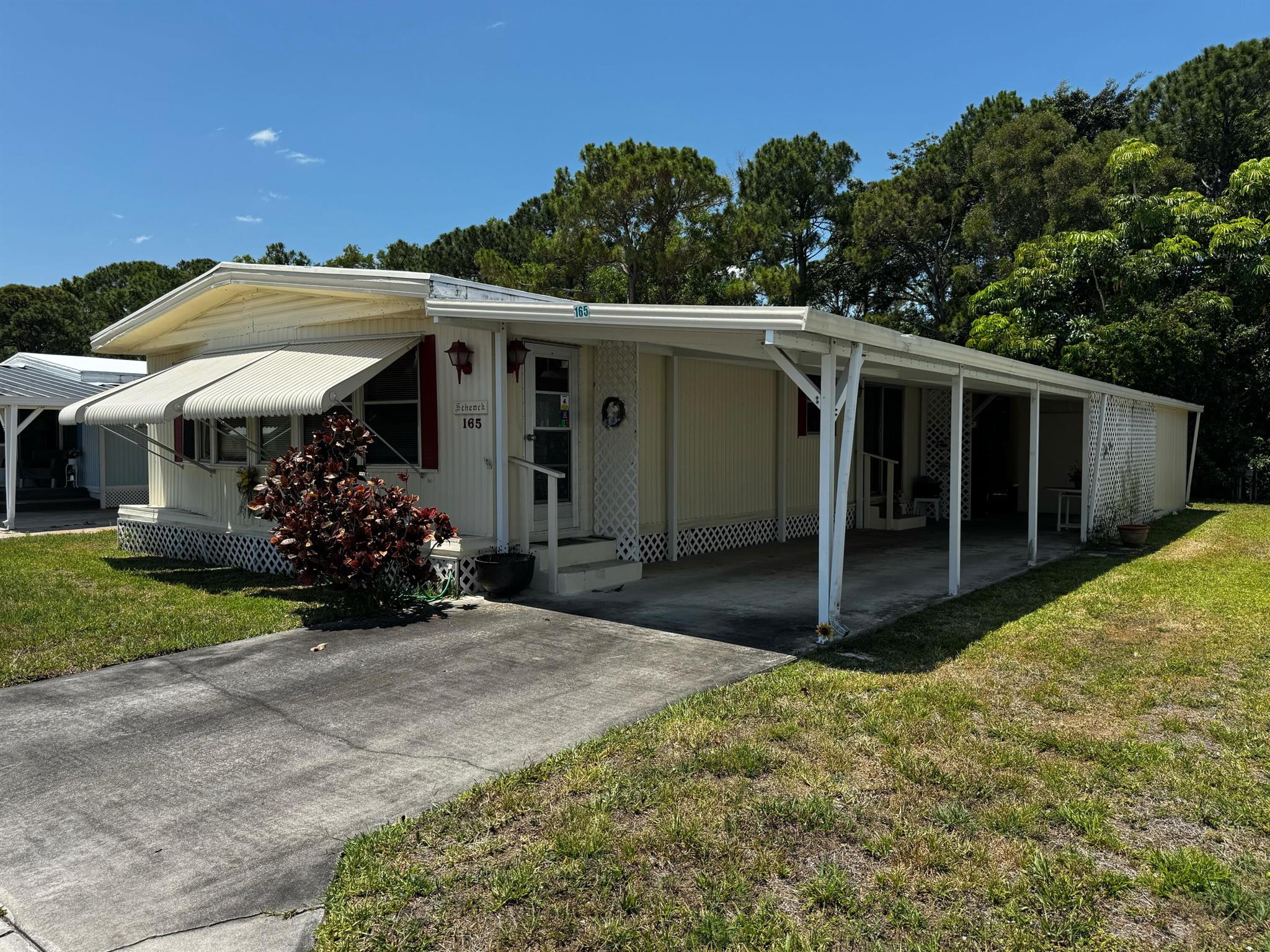 NO LAND-LEASE! LOW HOA $220/MO!  This home offers almost 1,400 SqFt of living space. Needs TLC and renovation but is livable.  Located steps from the community pool and clubhouse in an active community, 15 minutes from the beach, highways, shopping, and downtown Stuart. Co-op/HOA fee includes cable, sewer, trash, water, and amenities like a fitness center, library, game room, and shuffleboard. Storage lot for Boat/toys/RV available on site. Ideal for easy Florida living!