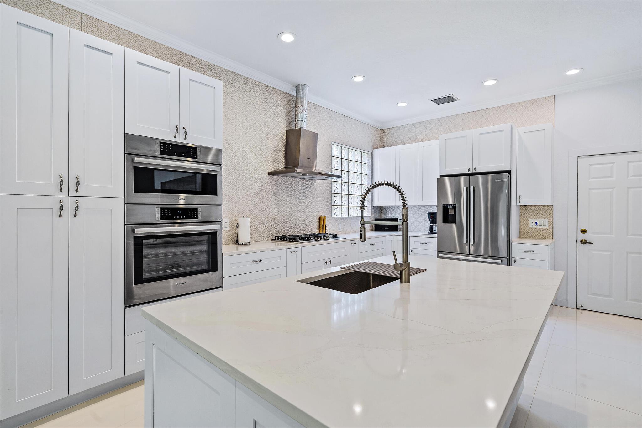 Beautifully renovated and filled with natural light, this bright and airy home features impact windows throughout for peace of mind. The spacious kitchen boasts a large white island, sleek white cabinetry, and modern finishes--perfect for entertaining. Enjoy tranquil water views from your private screened-in patio. Additional highlights include an in-unit washer and dryer for ultimate convenience.Located in the prestigious Club at Ibis--recognized as a Platinum Club of America--residents enjoy access to a 90,000 sq. ft. clubhouse, three Nicklaus-family designed 18-hole championship golf courses, five exceptional restaurants, a state-of-the-art fitness center and spa, and top-tier tennis and pickleball facilities.