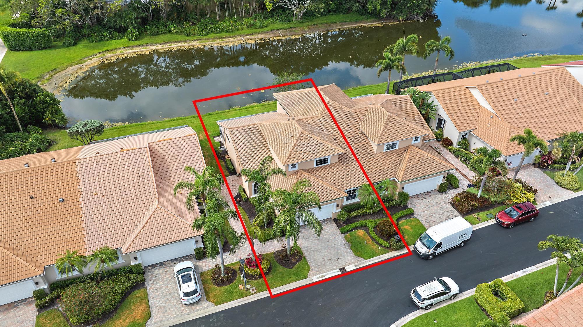 With a bright, Southern exposure overlooking serene lake views, and picturesque golf views to the west, this 2879 SF, 4BR/4BA+Den boasts soaring ceilings and redone porcelain floors. BRAND NEW ROOF AND GUTTERS, which is scheduled to be installed imminently! With two primary suites, one upstairs and one downstairs, this home boasts an extraordinary number of rooms for this price range. With FOUR bedrooms (2 upstairs; 2 downstairs), plus a downstairs Office, this Ecclestone-built home offers wonderful upgrades. The expanded, renovated kitchen features custom cabinetry, granite tops and a suite of stainless appliances. Brand new (2025) hot water heater. Enjoy extra storage space throughout, with a custom entertainment and storage unit built in the living room, a large pantry behind the staircase, a wall of storage cabinets in the garage, and custom closets in both primary suites. Soaring ceilings and redone porcelain tile flooring in the main living space are. This home is located within walking distance of Ibis's fine amenities, and is located across the street from the Sandpiper Cove pool. Enjoy the benefits of this pool area, just for the exclusive usage of Sandpiper Cove residents.  The Club at Ibis is an award-winning community that boasts a 90,000 sq. ft. clubhouse, three 18-hole Nicklaus-family Championship golf courses, five restaurants, a world-class fitness complex and spa, and incredible tennis and pickleball facility.