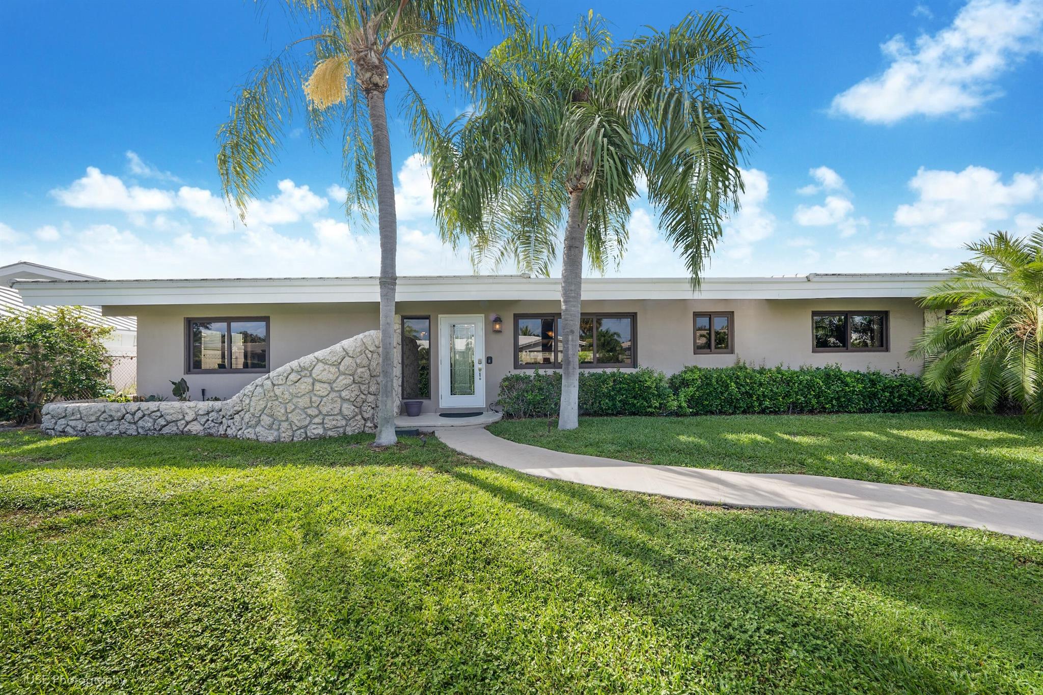 Nestled in the prestigious Venetian Isles neighborhood of Lighthouse Point, 4211 NE 26th Terrace presents an exceptional opportunity for those seeking to create their dream home. This spacious residence offers 2,529 square feet of living space, featuring 3 bedrooms, 3 bathrooms, and a versatile bonus room, making it an ideal canvas for customization. Positioned on a beautifully landscaped, generously sized lot, this home is a true sanctuary of privacy. The lush surroundings and mature greenery create a tranquil escape in the heart of the city. The outdoor oasis is complete with a stunning coral rock waterfall that cascades over the pool, a built-in spa for relaxation, and a charming sandbox for children to enjoy--perfect for family gatherings and entertaining. Built with durability in mind, the property is hurricane-ready with all impact-resistant glass throughout. The roof, approximately eight years old, provides peace of mind, while the hot water heater is just about five years old. The home is equipped with two air conditioning units&#x14;one newly installed and the other approximately nine years old&#x14;ensuring year-round comfort.

Inside, the home boasts a unique charm with original woodwork and stone accents, offering character rarely found in newer properties. Although it requires some updating, the potential here is undeniable.
Located in Venetian Isles, one of Lighthouse Point's most coveted communities, you are minutes away from waterfront dining, world-class marinas, and pristine beaches. This is your chance to reimagine a distinctive property in an unparalleled location.