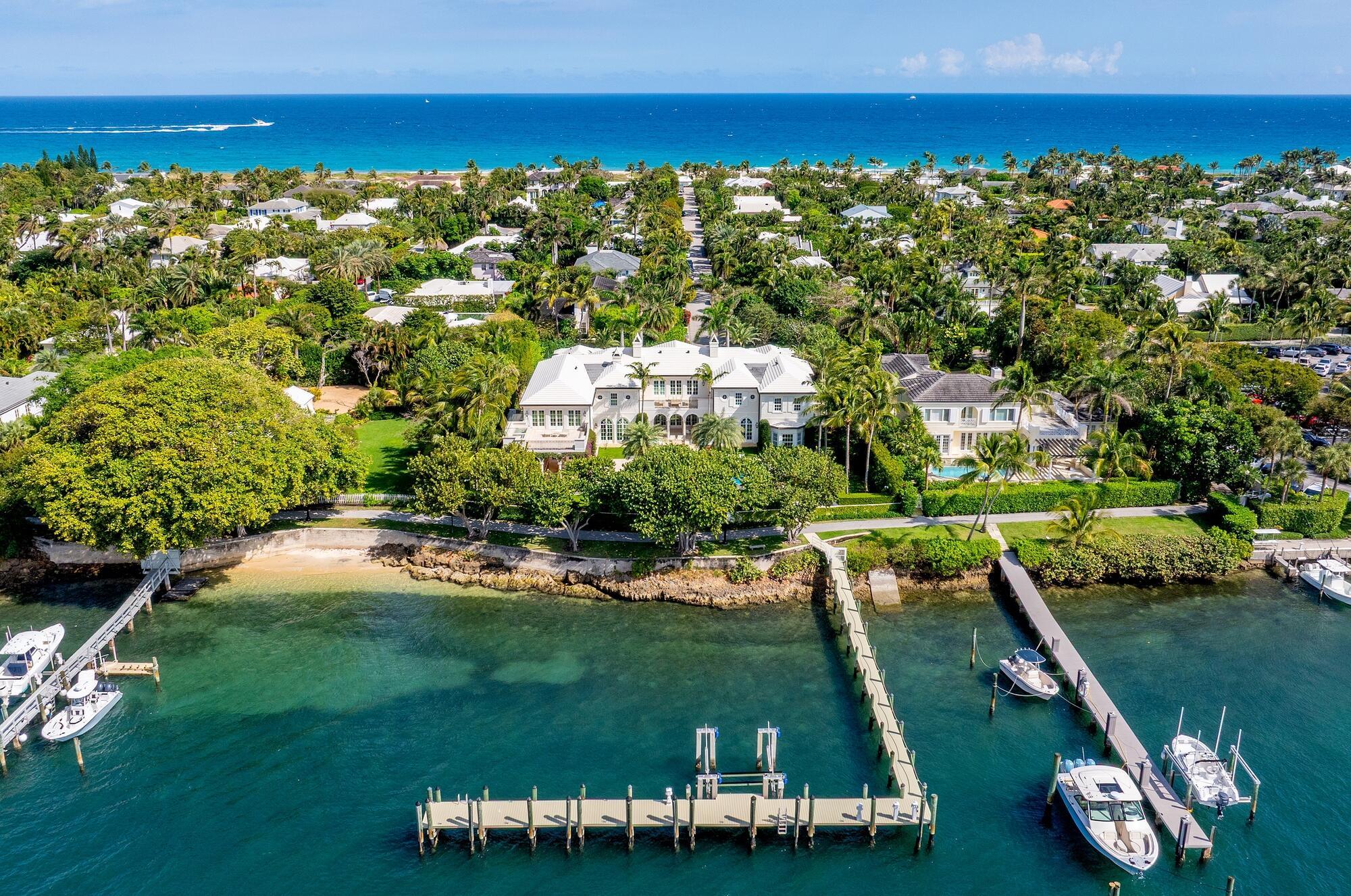 Pristine and rarely available Intracoastal front estate located in Palm Beach's serene North End. Highlights include 7BR/9.3BA, 150+/- feet of Intracoastal frontage, deep-water dock with boat lift, and over 17,000 total square feet. This rare and luxurious home boasts breathtaking lake and sunset views from all principal rooms. Gorgeous Island Colonial with stunning stone and hardwood flooring, high ceilings, and great natural light. First and second floor Primary Suites with dual baths and closets. Formal living room with fireplace and French doors leading to covered loggia. Stunning library with built-ins, formal dining room with butler's pantry, and light-filled family room. Eat-in entertaining kitchen and professional chef's kitchen both equipped with top-of-the-line appliances. The second floor Primary Wing features a large open terrace with built-in cold plunge and spa. Atop the North and South Garages are two fabulous flex spaces each with a full bath and closet - one currently set up as a staff room and the other as an exercise room. Additional highlights include two laundry rooms, elevator, and ample storage space. This home is perfect for both indoor and outdoor entertaining with multiple covered loggias and spacious terraces. Large swimming pool with sun shelf and spa are surrounded by beautifully landscaped grounds.
