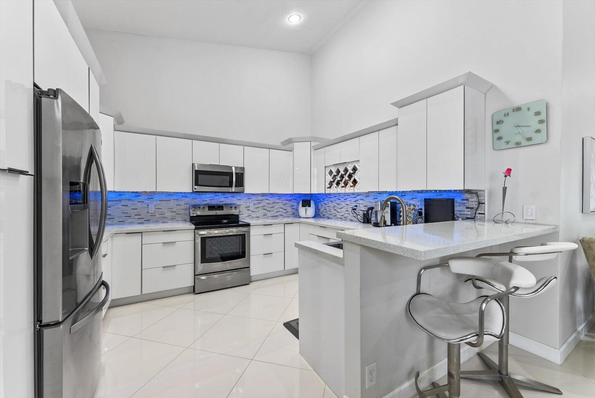Welcome to your Dream Home! This is a stunning 2/2 Villa that truly has it all. The home is completely remodeled with beautiful white tiled floors throughout for that clean look and feel, spacious kitchen with white granite countertops, stainless steel appliances and a skylight for natural light. The enclosed terrace faces the water with entrances through sliding glass doors in both the living room and master bedroom. Master B/R has double closets  and a connecting bath with separate tub and shower. The new guest bathroom also has a shower.  Tub/sink and storage closet in Utility Room,1 car garage with Epoxy floor, and accordion hurricane shutters. NEW ROOF completed in 2020 with no special assessments ! This is truly a Great Property. You don't want to miss this opportunity.... Villa San Remo is a 24 hr manned gated all age community that offers BRAND NEW AMENITIES, resort style pool, playground, basketball-tennis-pickleball courts, exercise room &amp; clubhouse. This is a ready to move-in villa .  NEW ROOF  completed in 2020 with no special assessments !